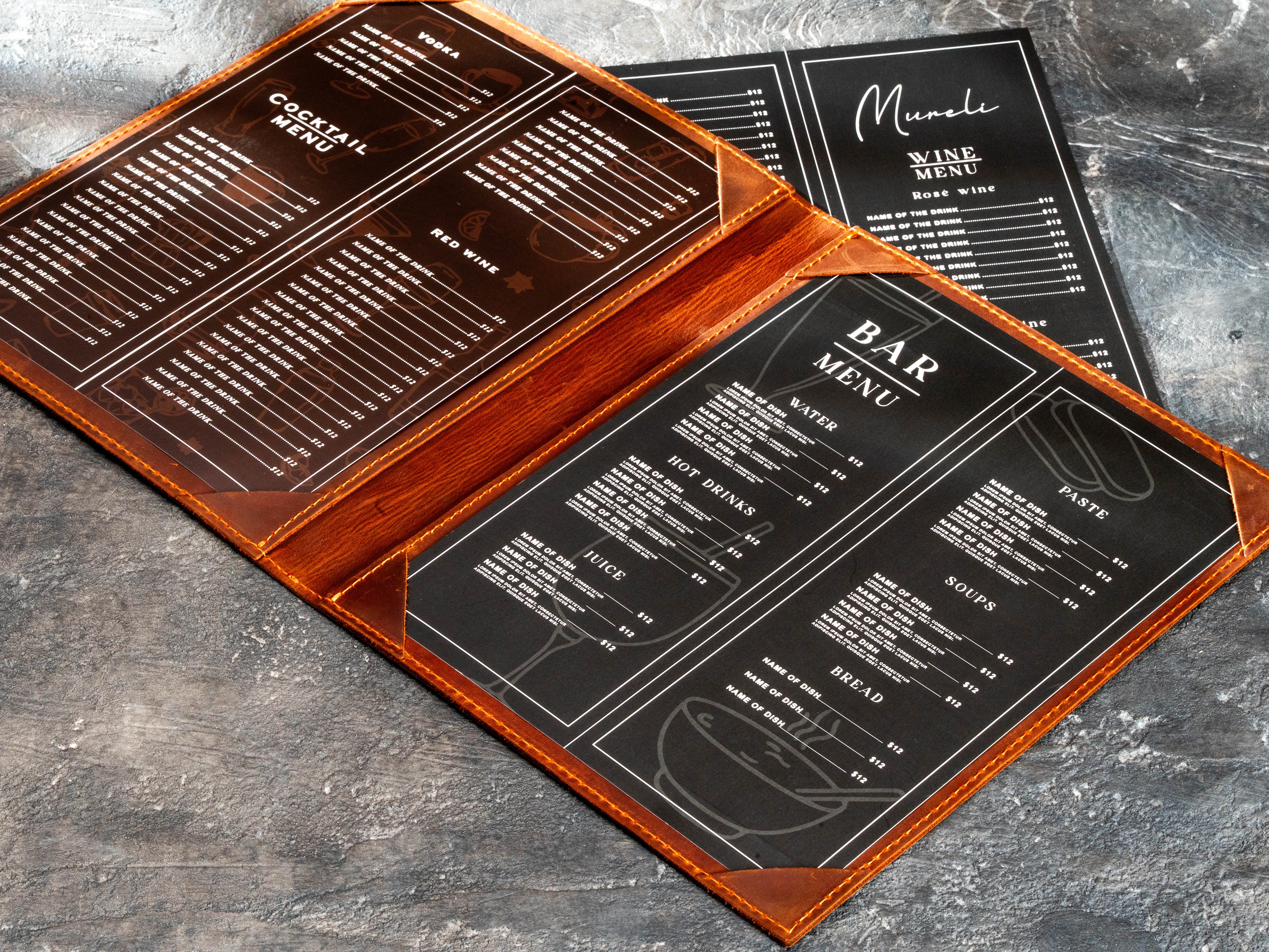brown leather restaurant menu cover with printed bar and cocktail menu sheets secured by corner holders