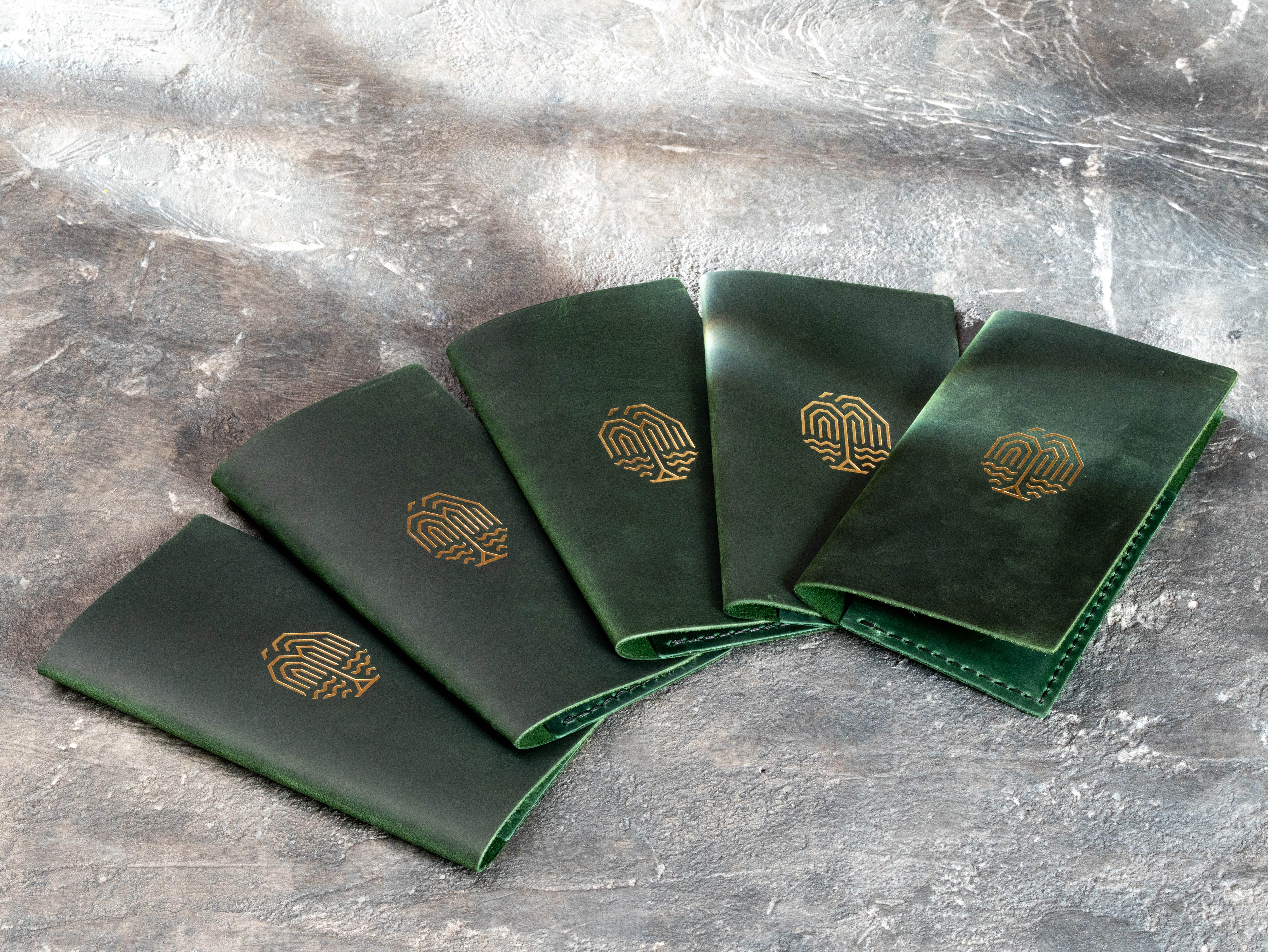 Green leather restaurant bill holders with gold logo, Design #1, made as a custom bulk order for a restaurant client.