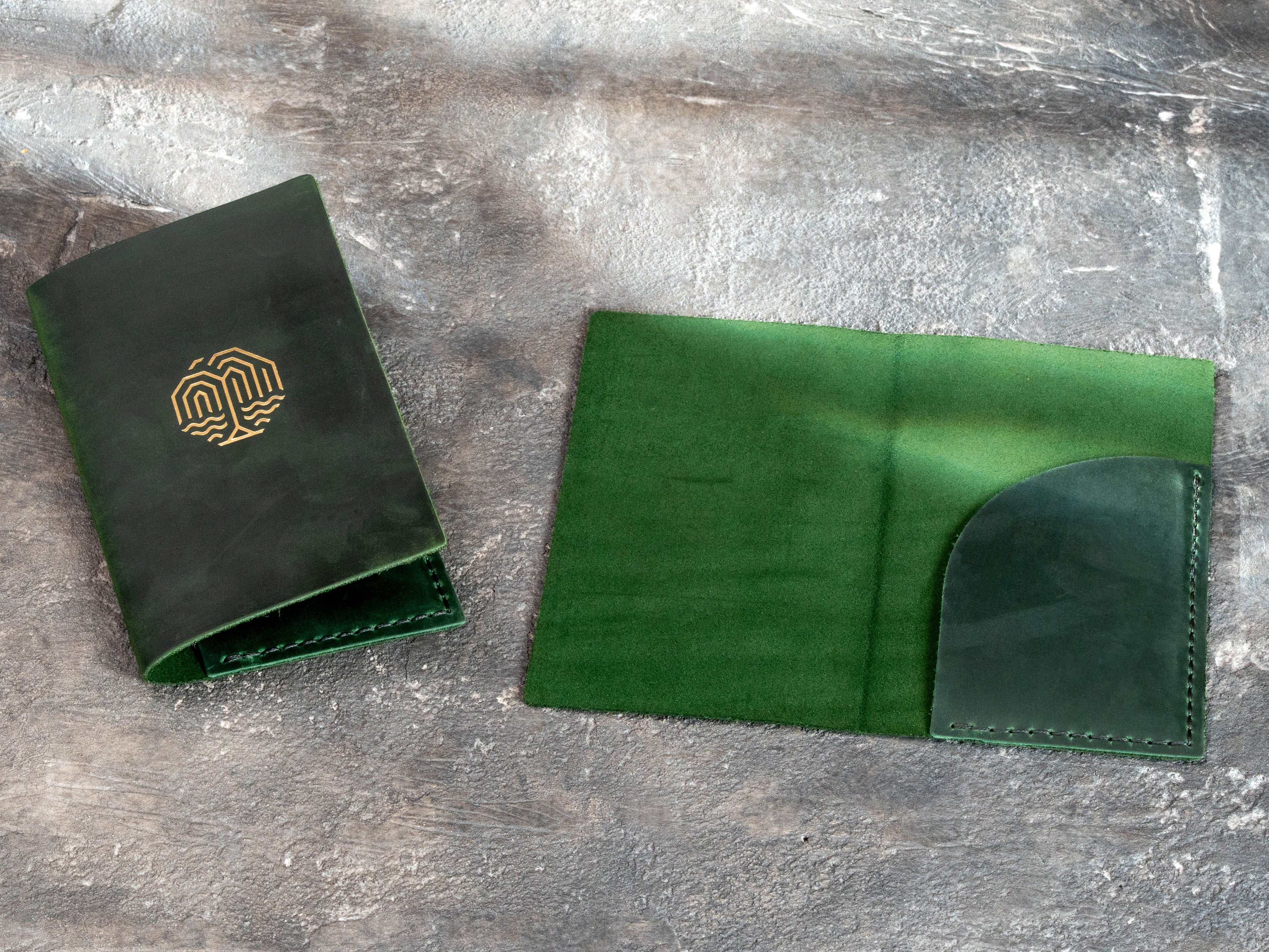Interior detail of green leather bill holder with a simple pocket layout and matching green stitching.