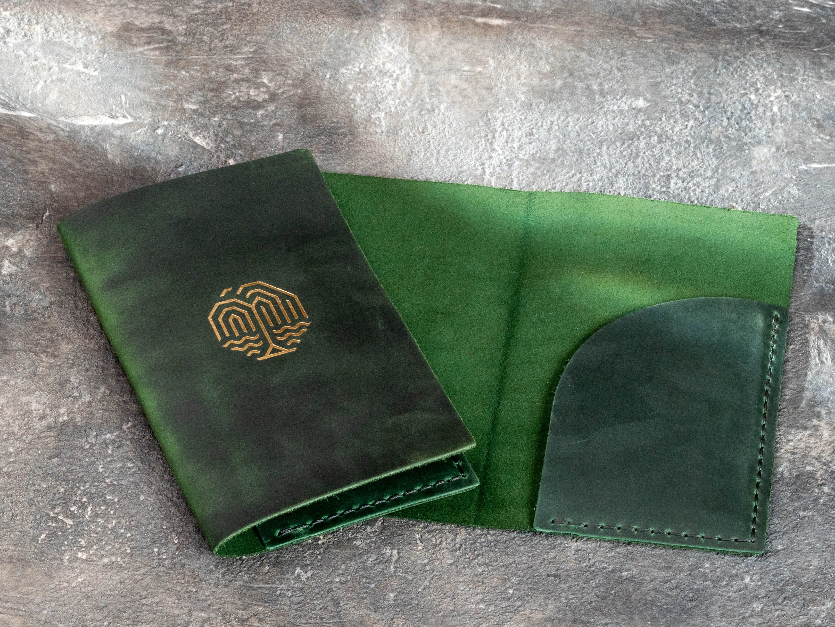 Custom restaurant check folders in dark green leather with gold logo, created as a coordinated batch.