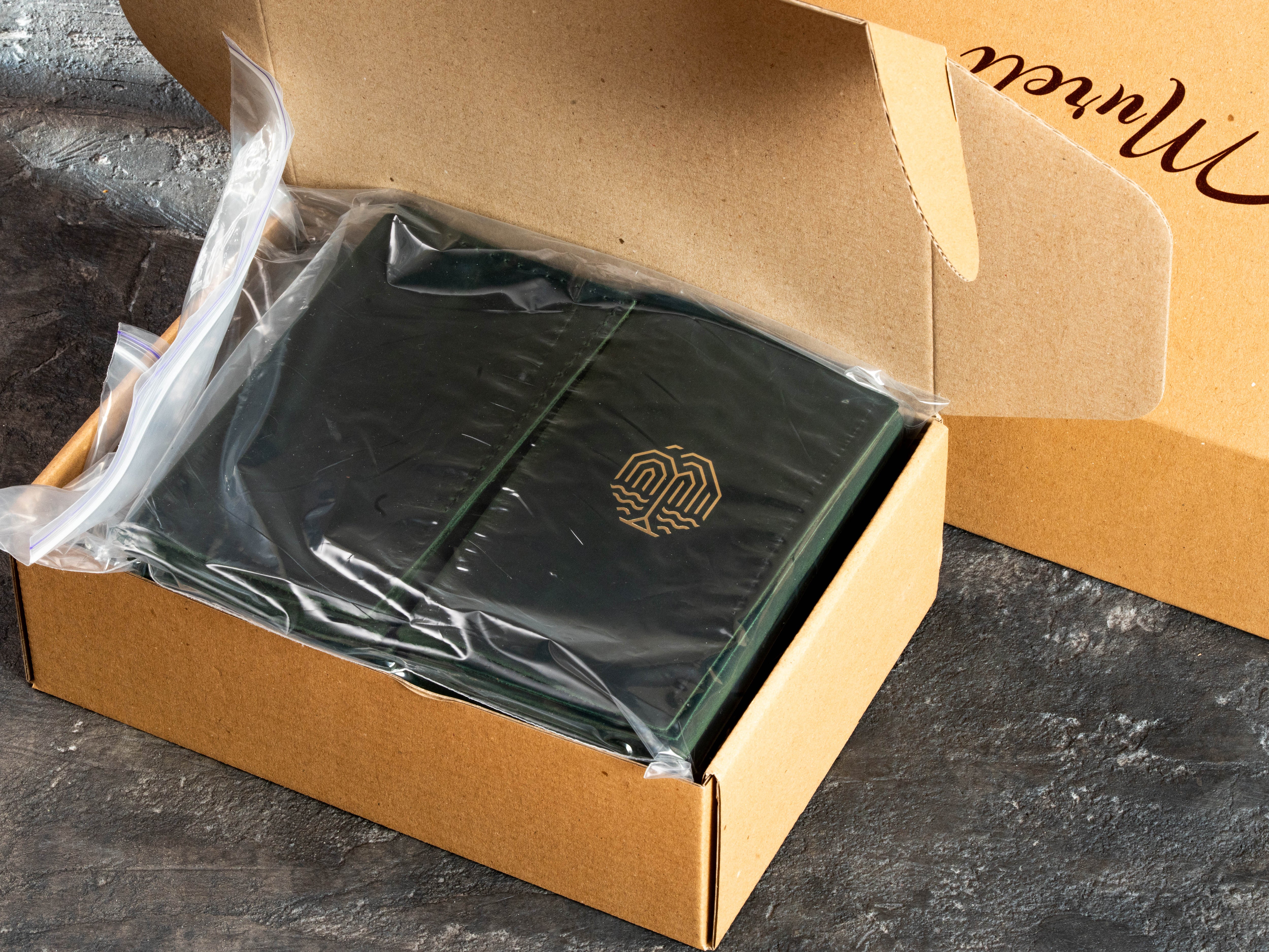 Restaurant bill holder batch packed in a box before shipment to the client, showing the completed production order.