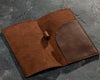 Waitstaff using leather check holder in a restaurant setting