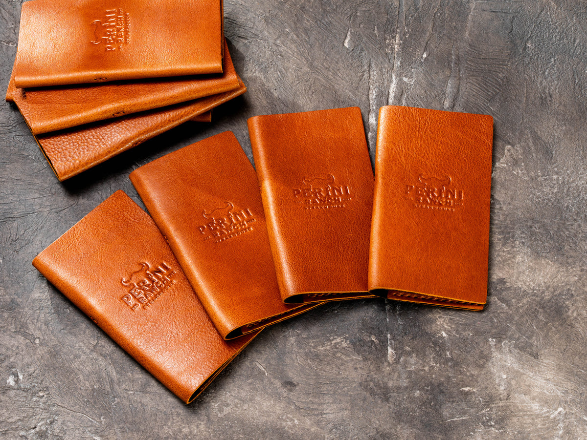 Camel leather restaurant check presenters with blind embossed custom logo for hospitality service