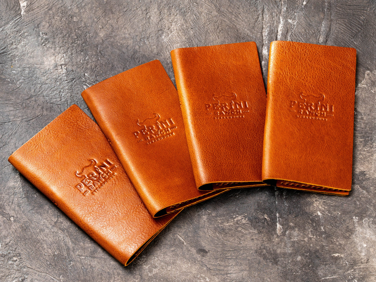 Set of coated leather restaurant bill presenters with custom embossed business logo