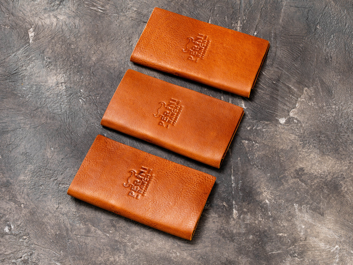Durable camel leather guest check folders with protective finish and stitched edges