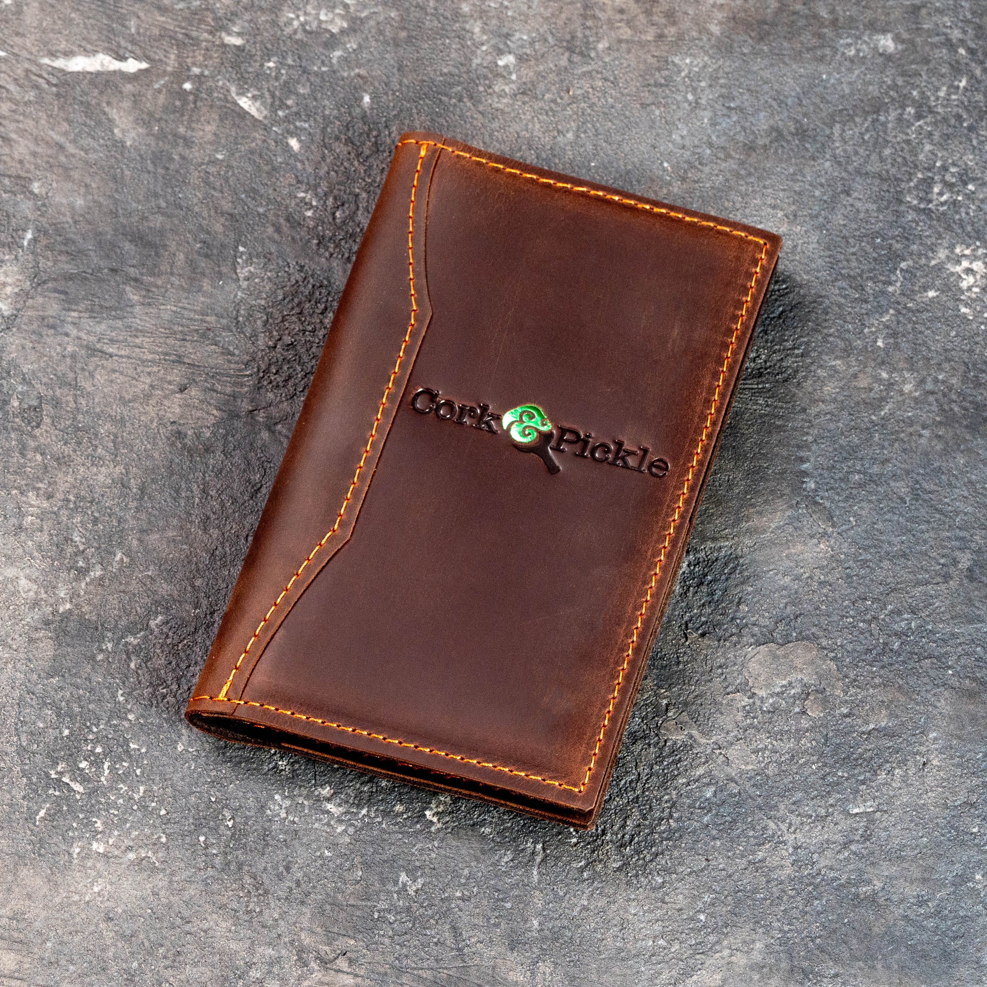 Open and closed premium leather check presenters with organized interior pockets for bills, cards, and cash