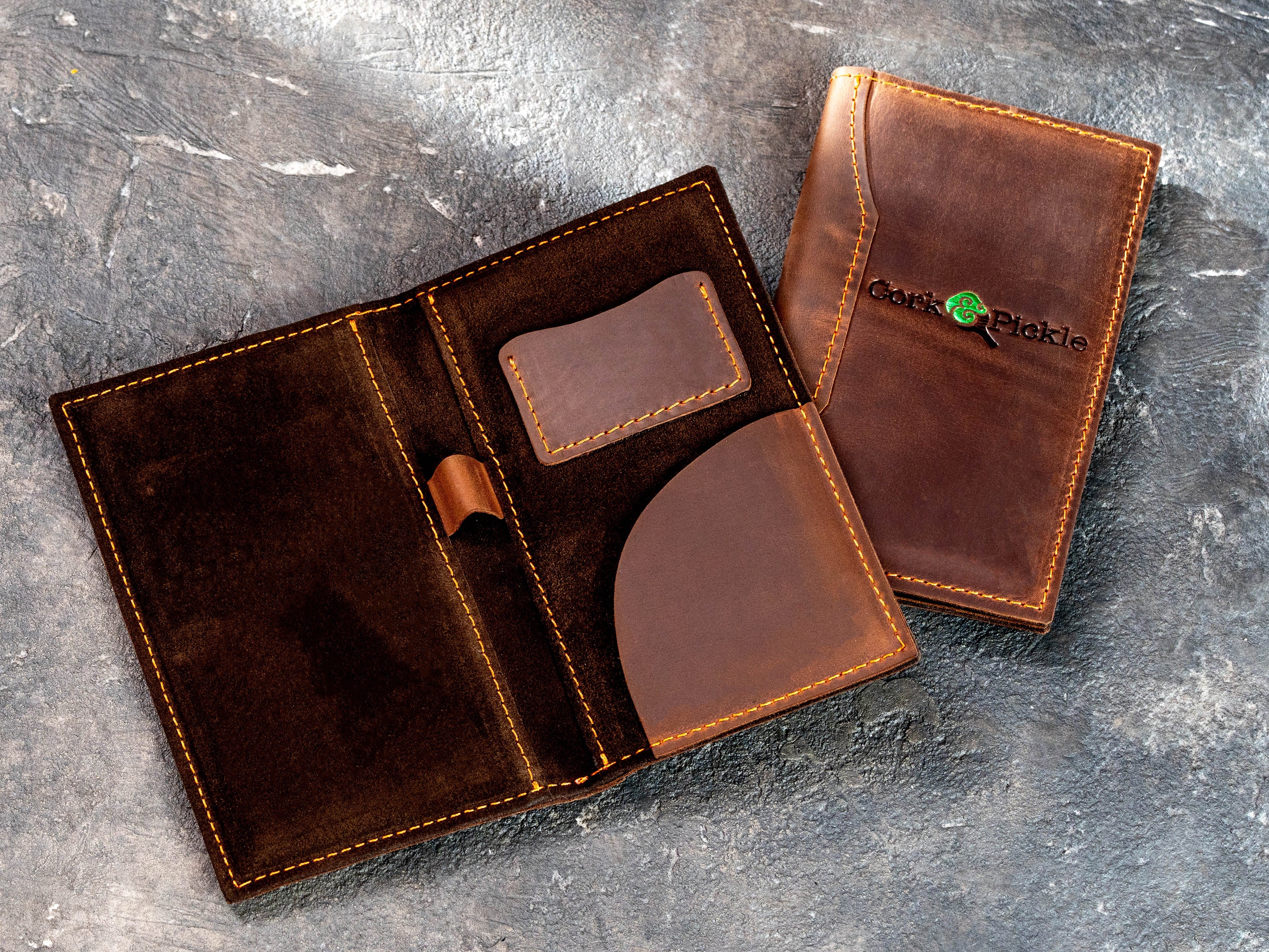 Custom brown leather restaurant check presenter displayed with a stack of matching branded bill folders