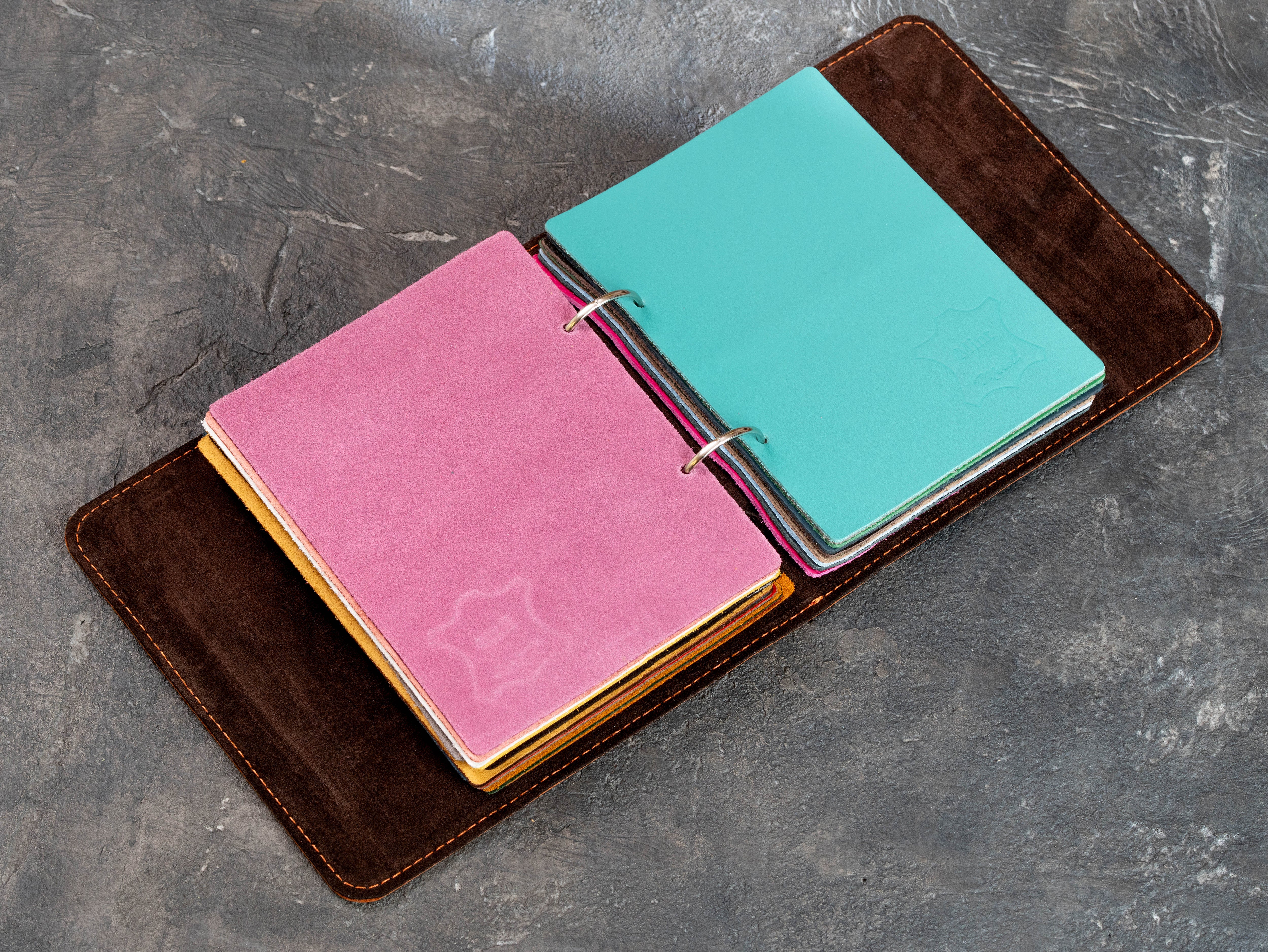 Open Mureli leather swatch binder with turquoise and pink leather samples in different textures