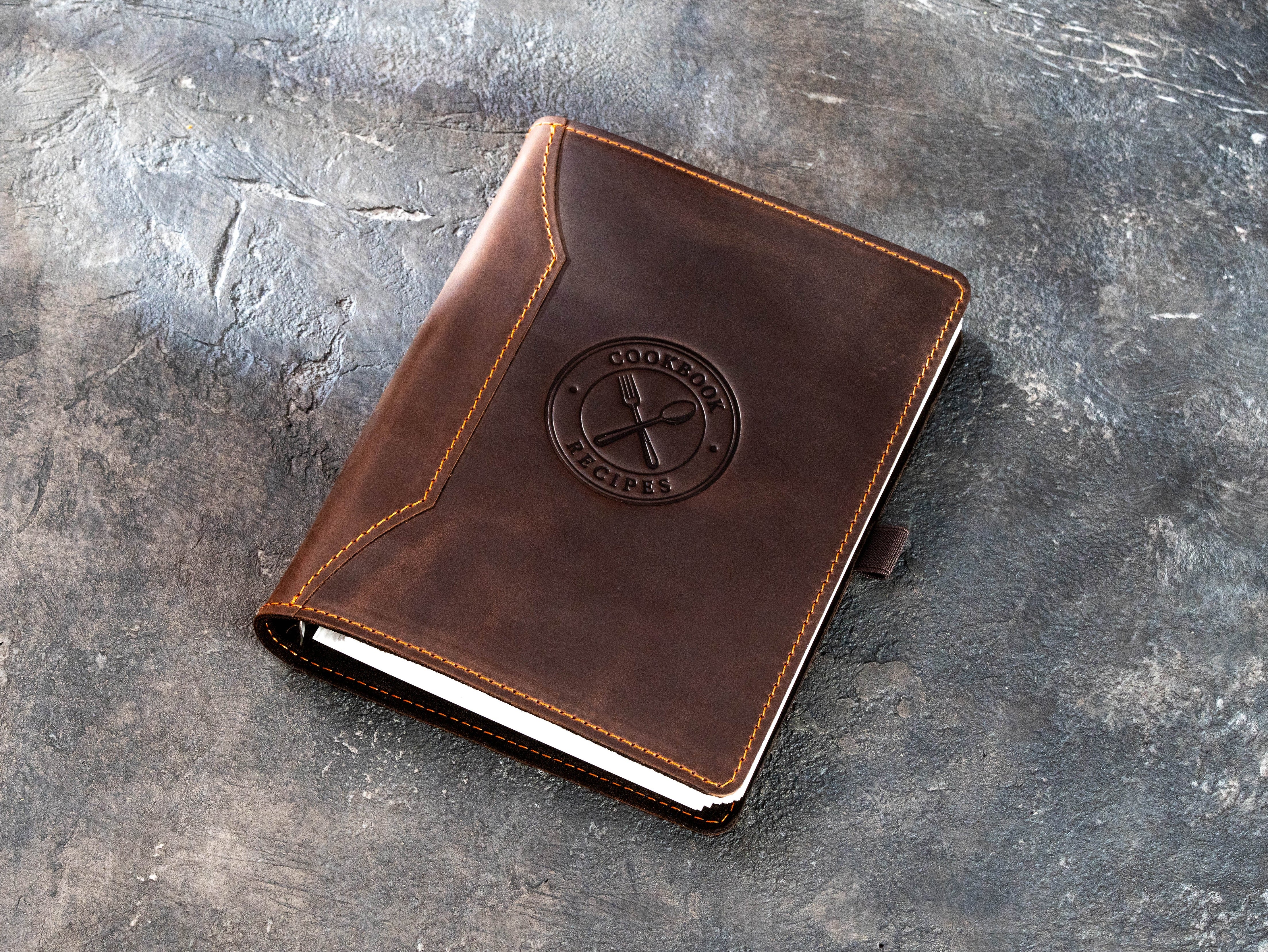 Closed brown leather cookbook binder Design 3 with embossed fork and spoon emblem