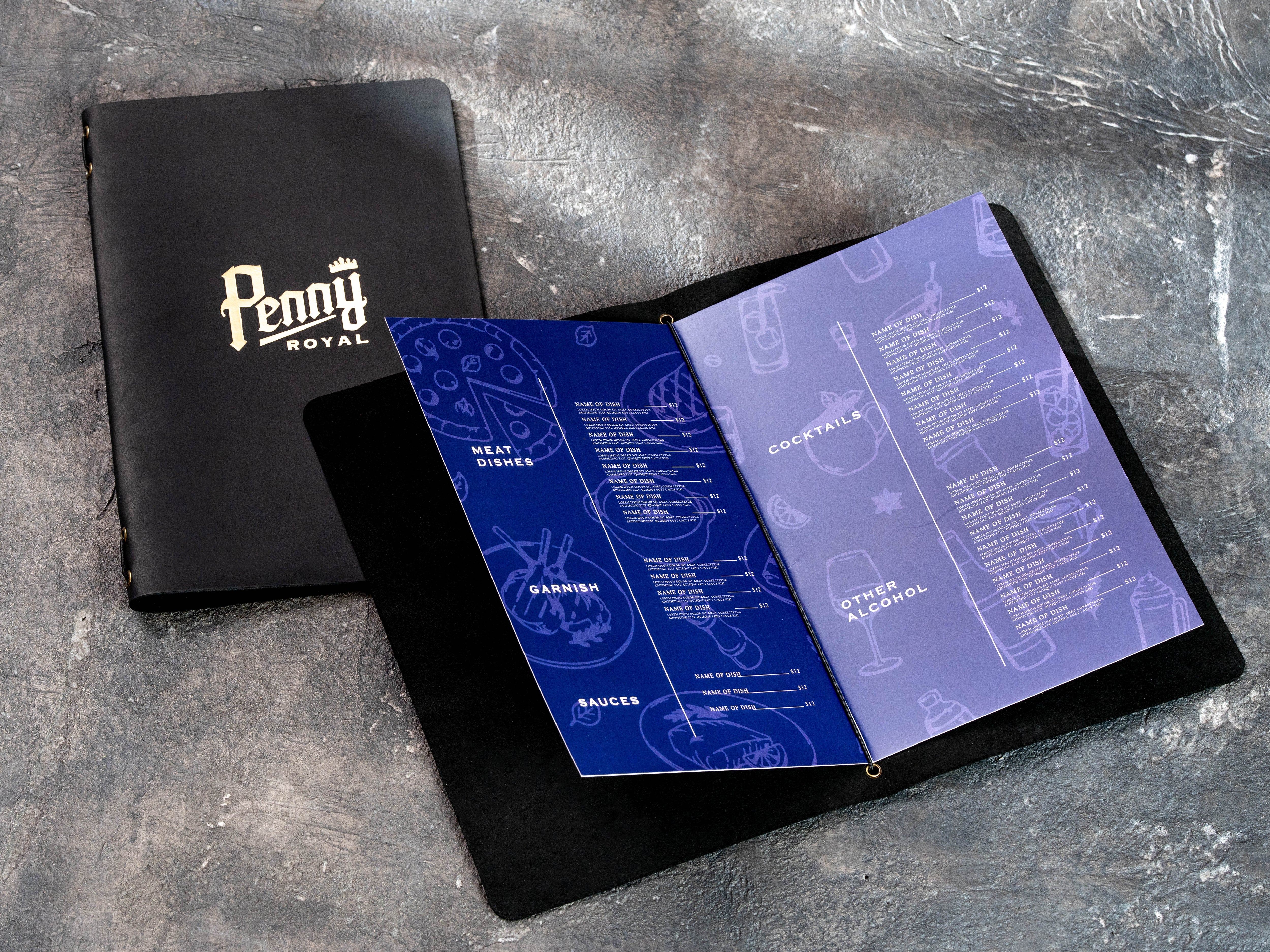 Black leather Penny Royal menu covers arranged in a stack with custom gold foil branding