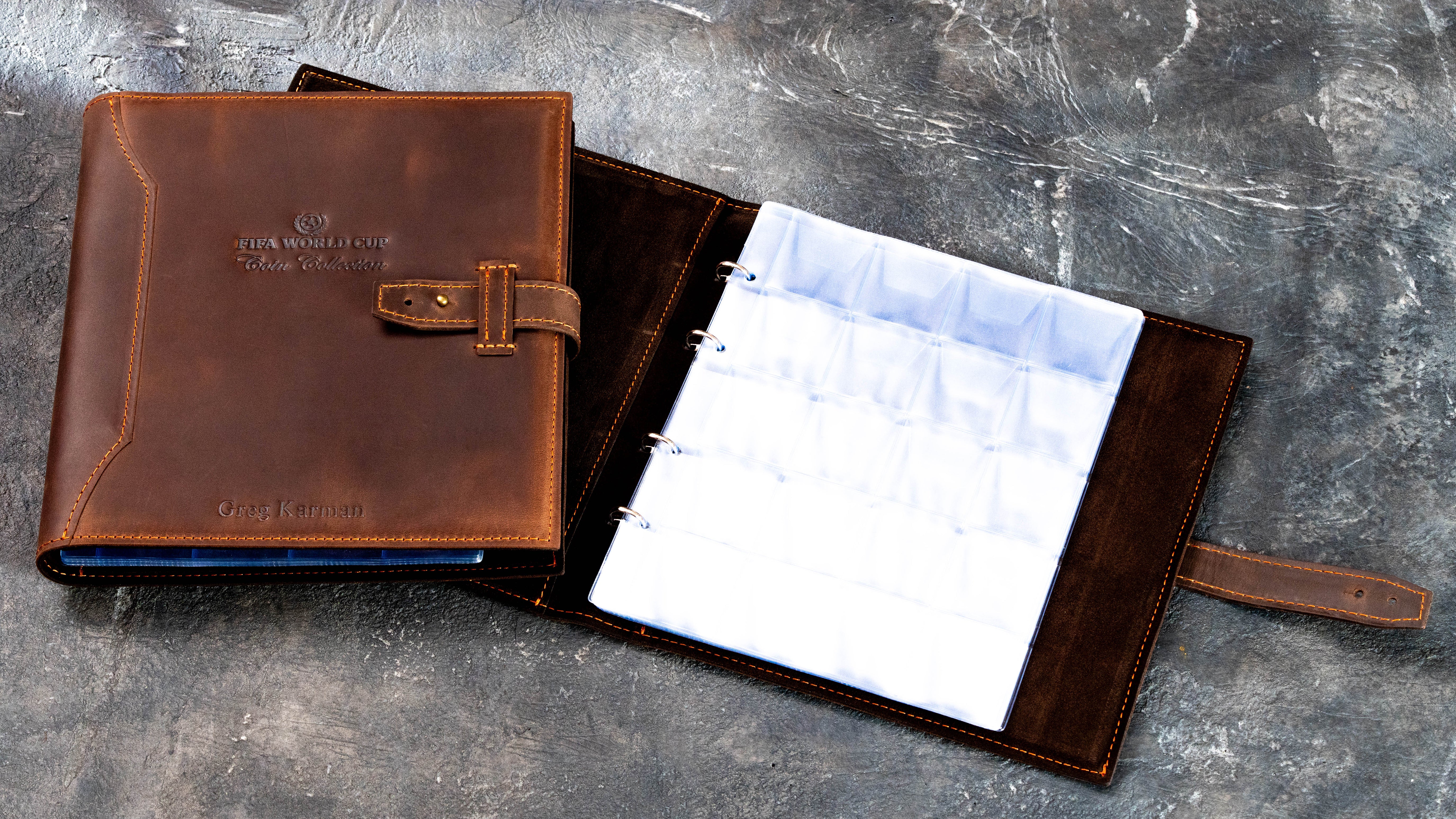 Open brown leather coin collection album with suede lining and removable sheets holding up to 200 coins