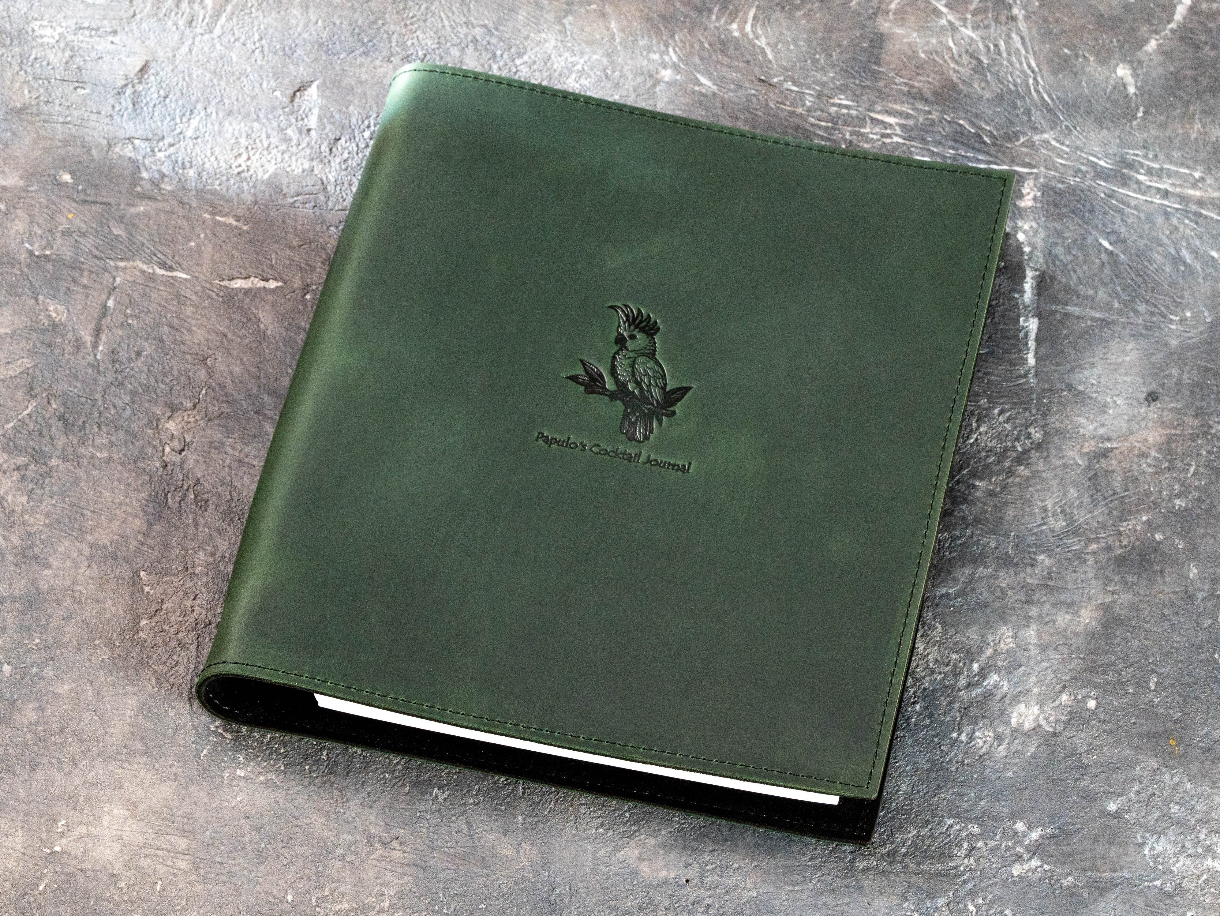 Personalized green Crazy Horse leather cocktail recipe binder with Papulo’s Cocktail Journal cockatoo design