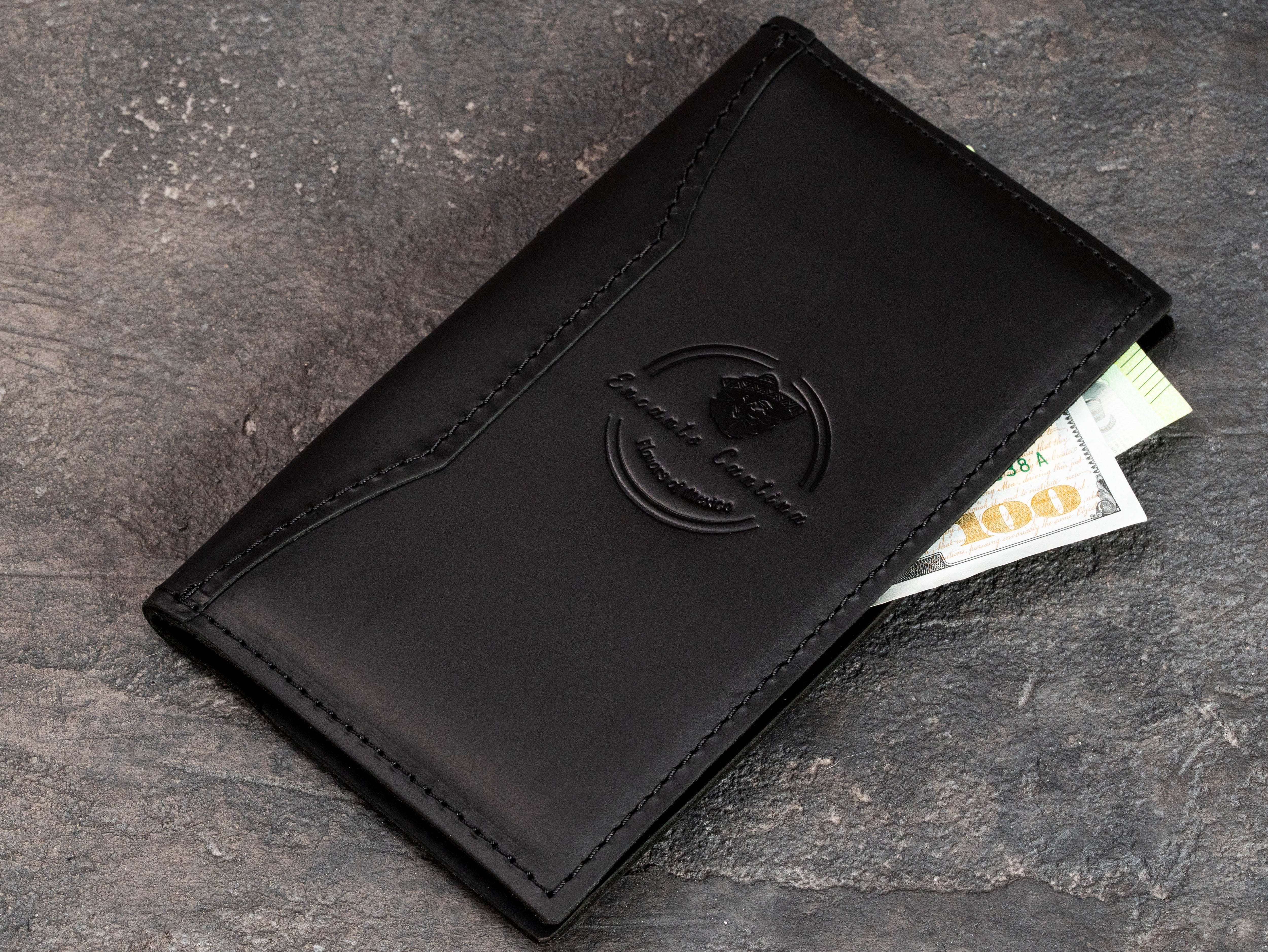 Black leather restaurant check presenter with blind embossed Encanto Cantina logo and receipt pocket