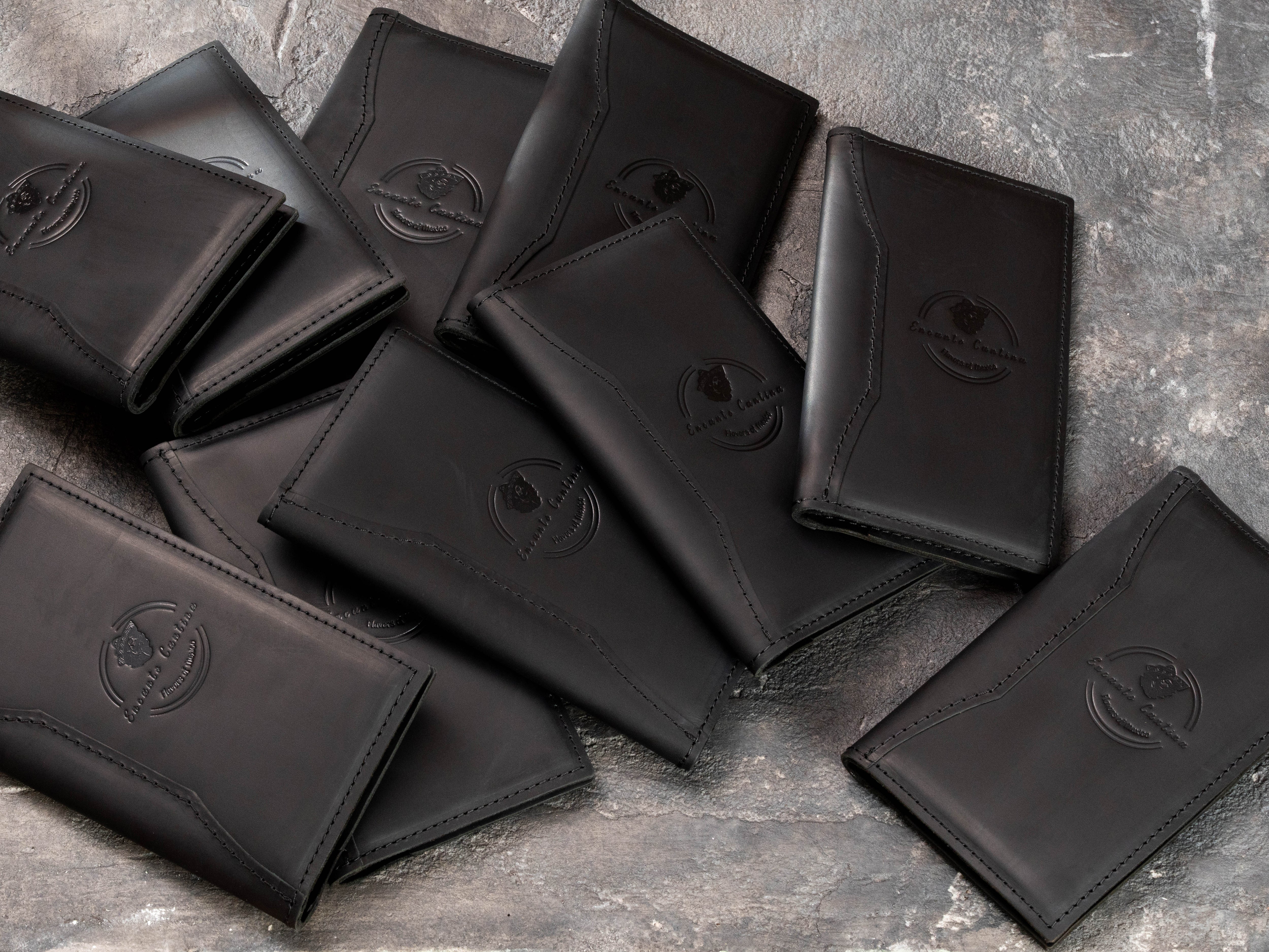 Large restaurant order of personalized black leather guest check folders with blind embossed logos