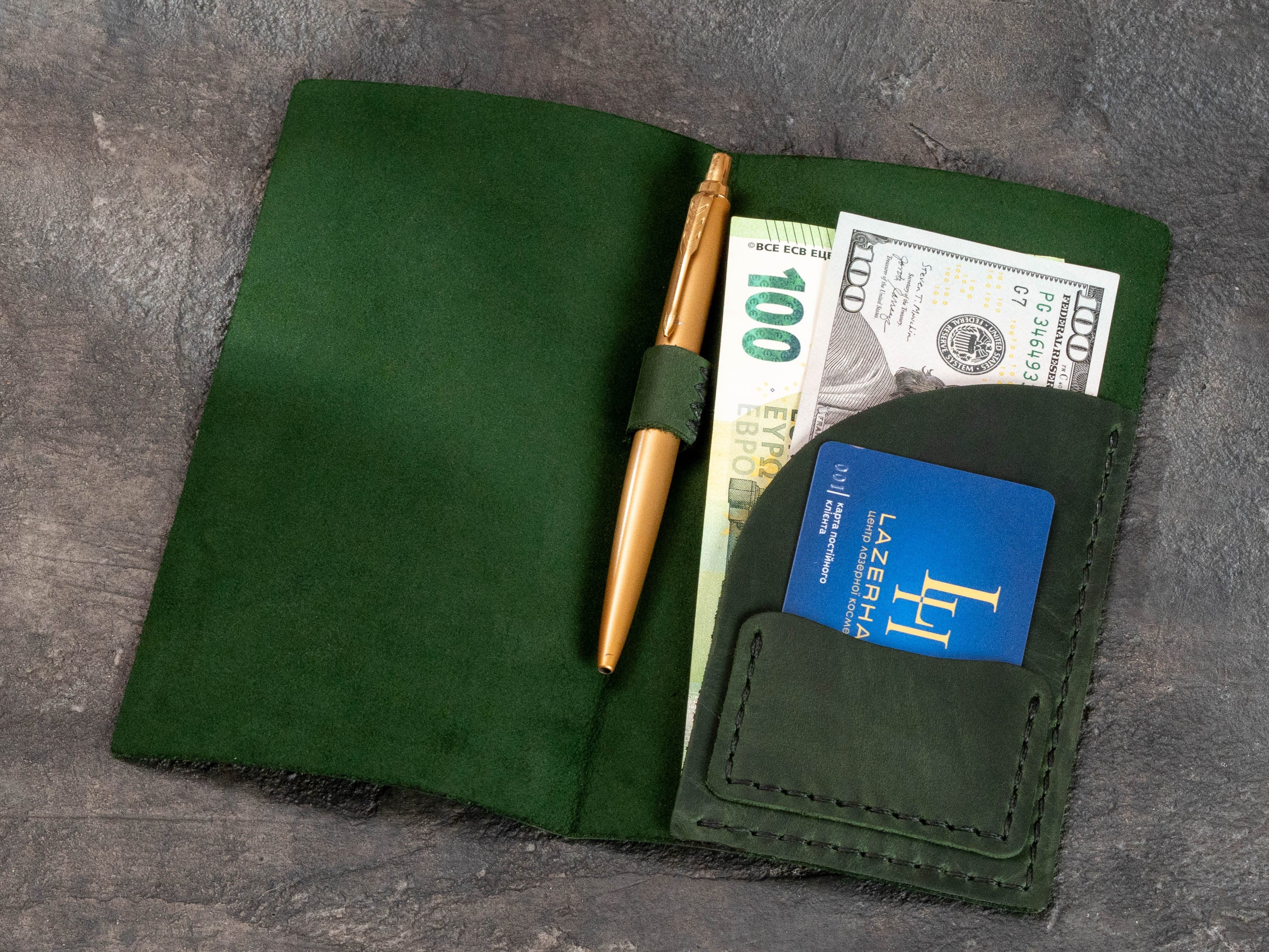 Green leather check presenter with custom gold logo and matching restaurant branding