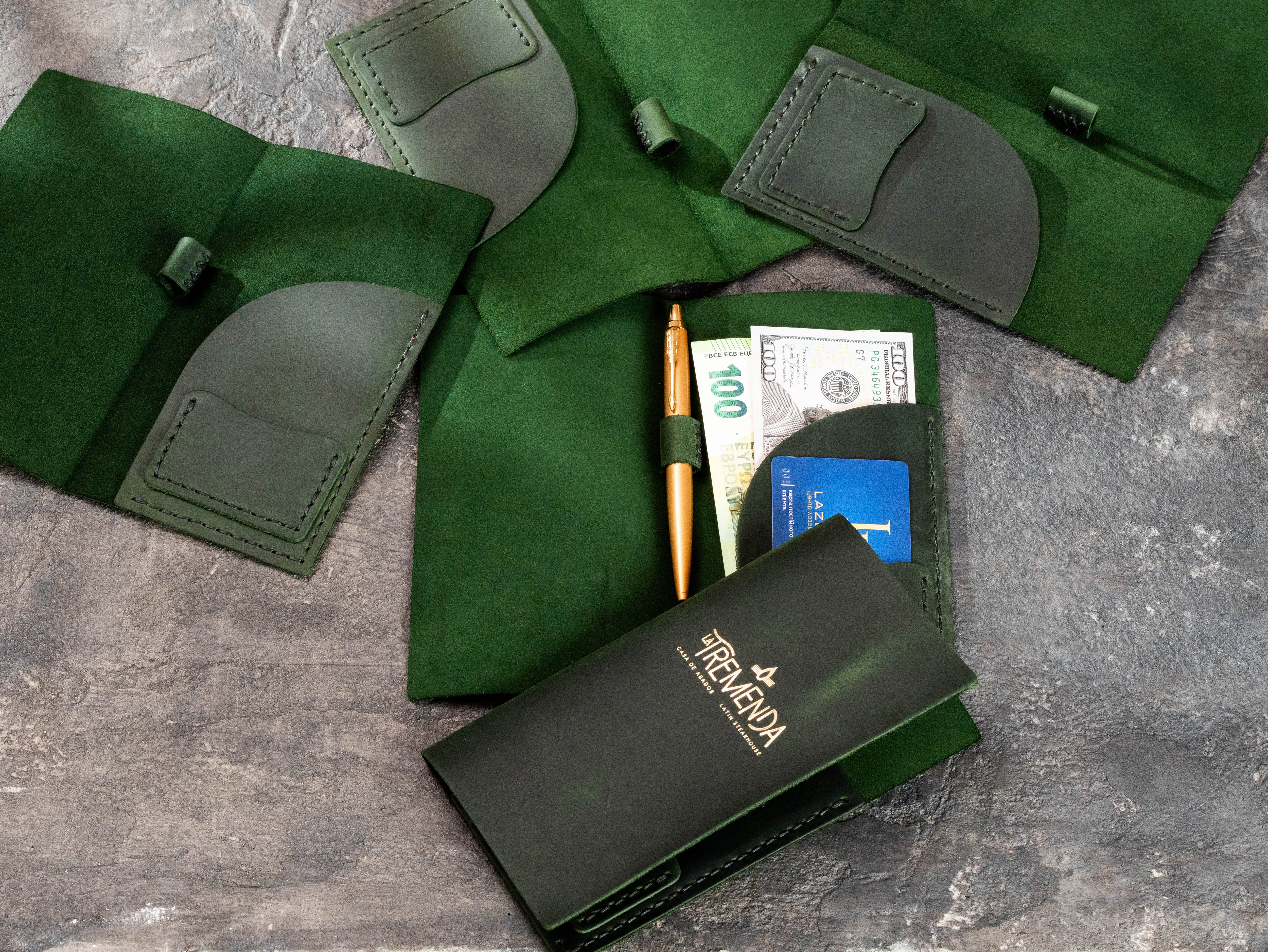 Green leather check presenter interiors with card slots, receipt pocket and pen holder
