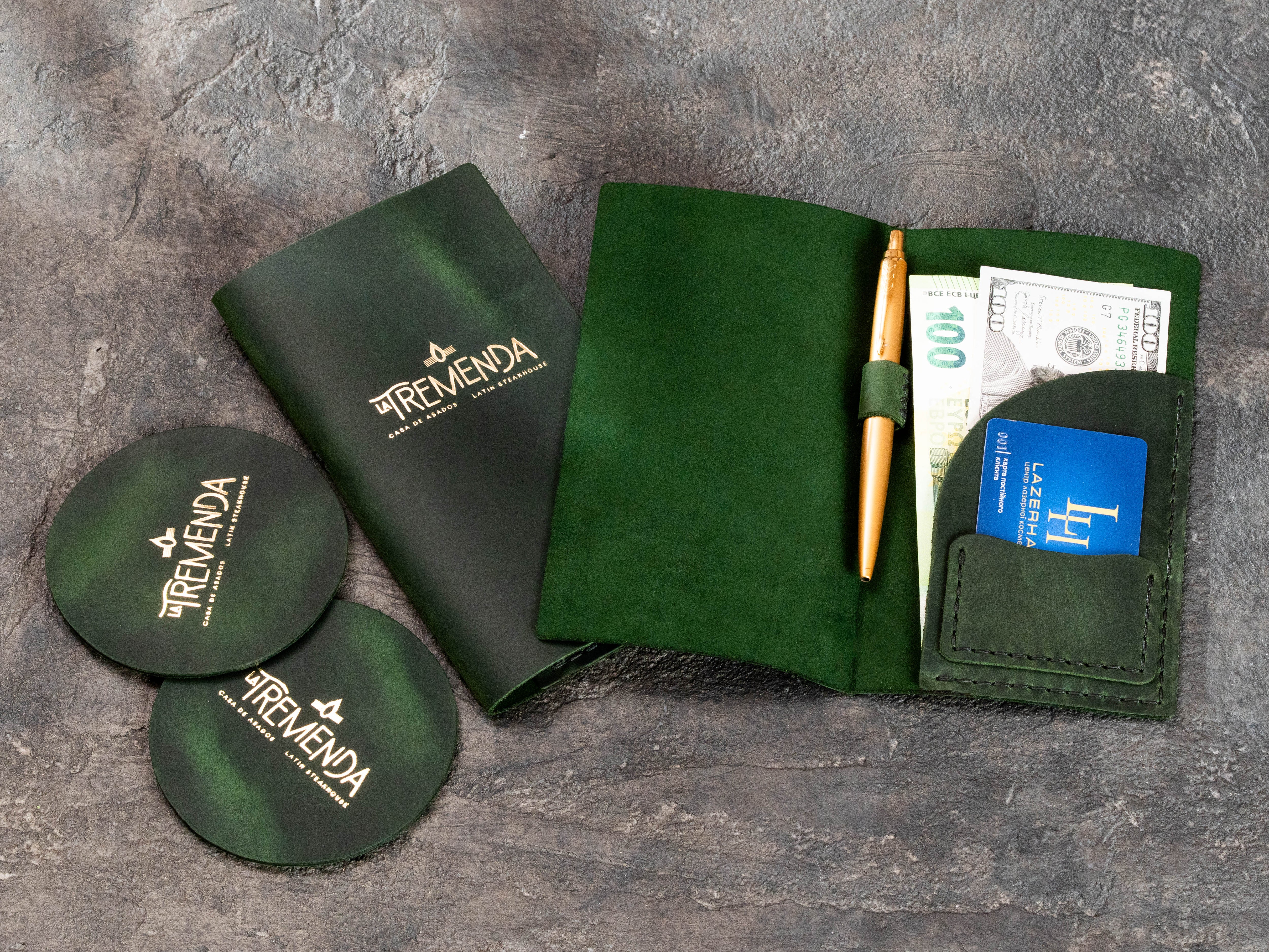 Branded green leather check presenter with matching custom leather coasters for a steakhouse