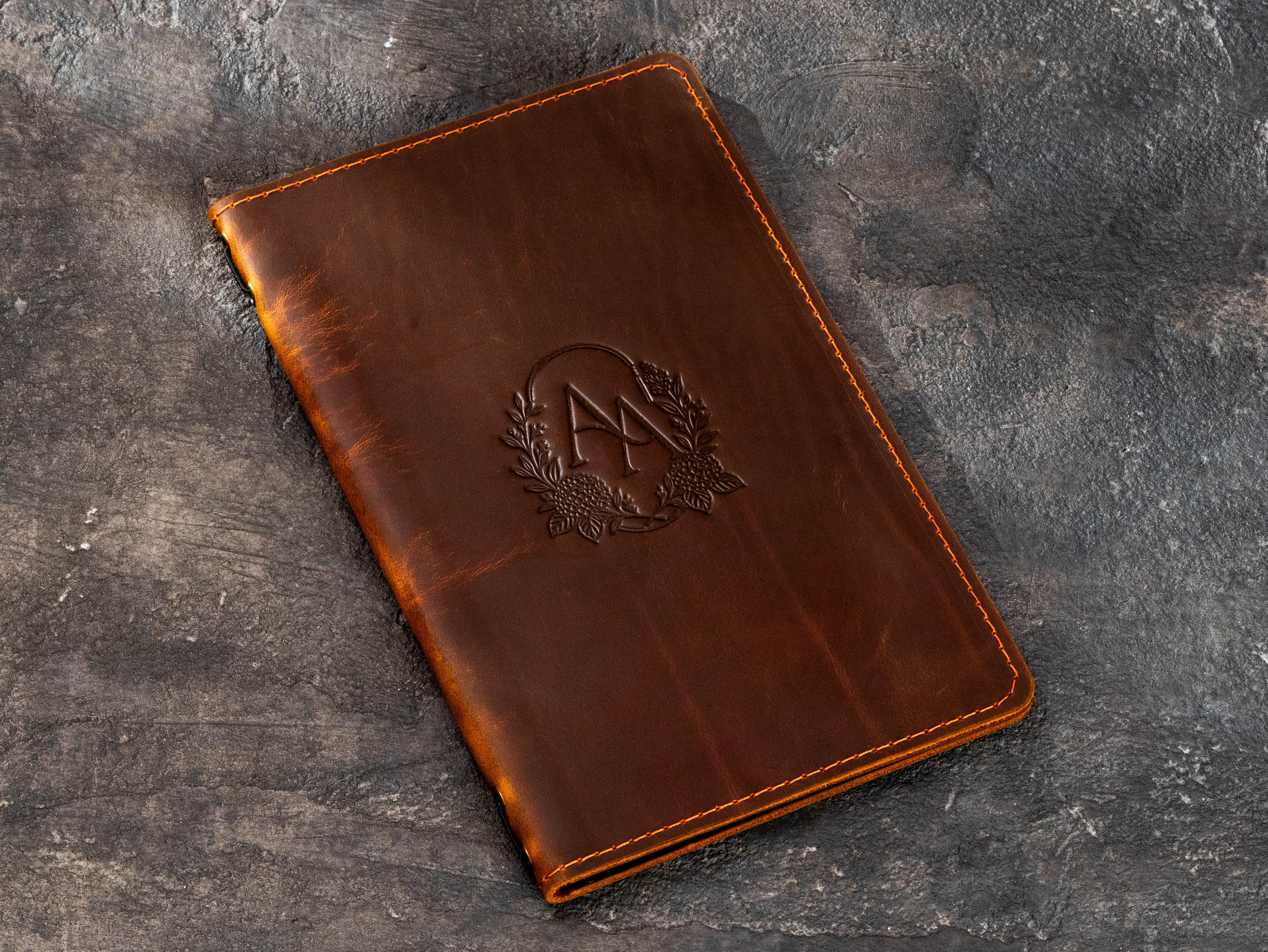 Personalized brown leather menu cover with blind embossed floral monogram and vintage leather finish