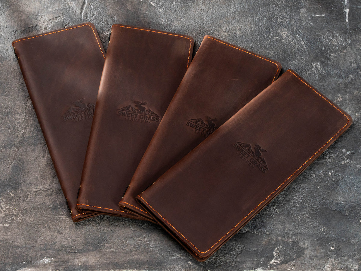 Bulk brown leather restaurant bill holders with custom embossed logo for taverns, lodges and rustic restaurants
