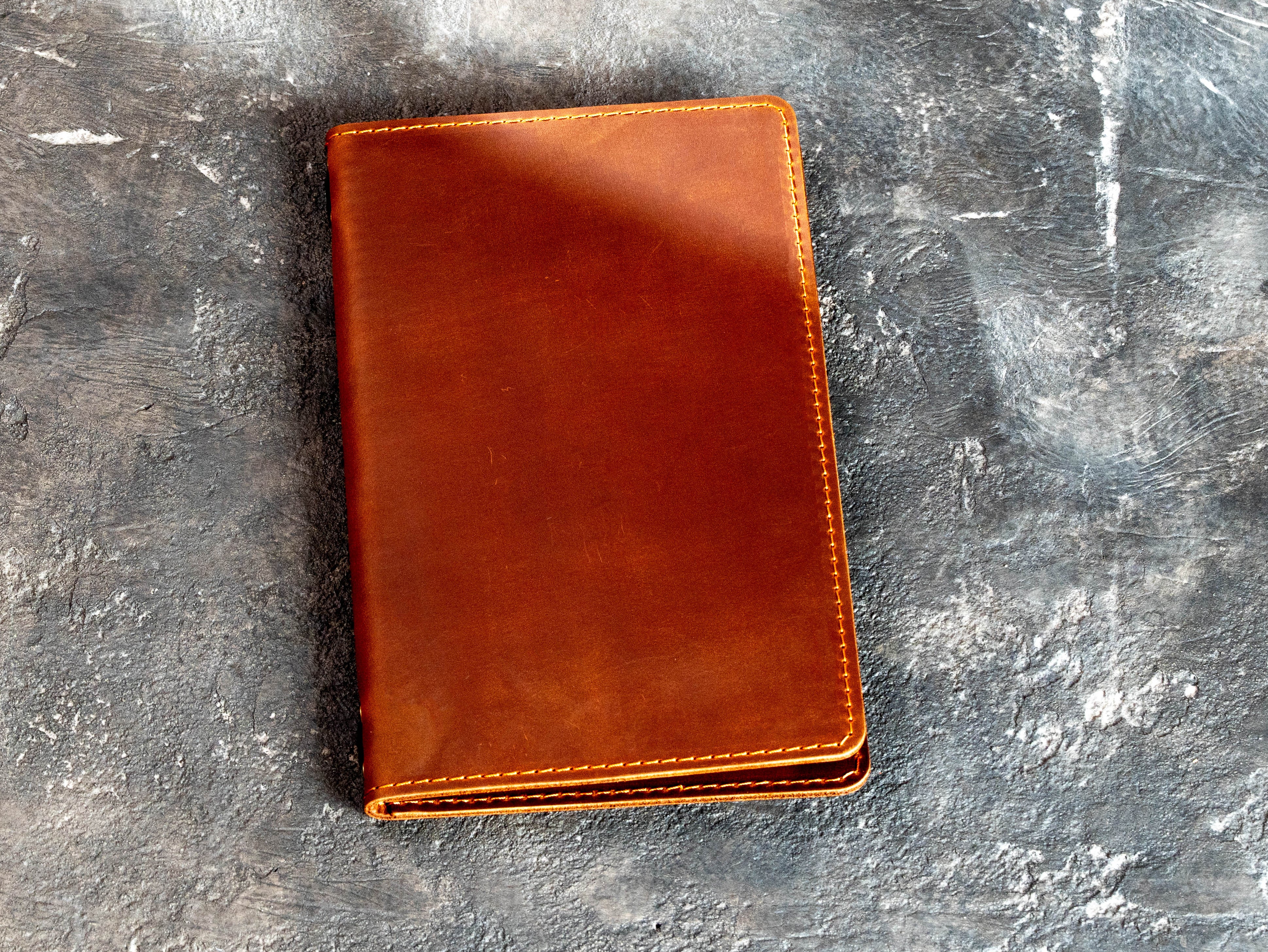 Back view of a chestnut leather restaurant menu cover with a smooth vintage finish