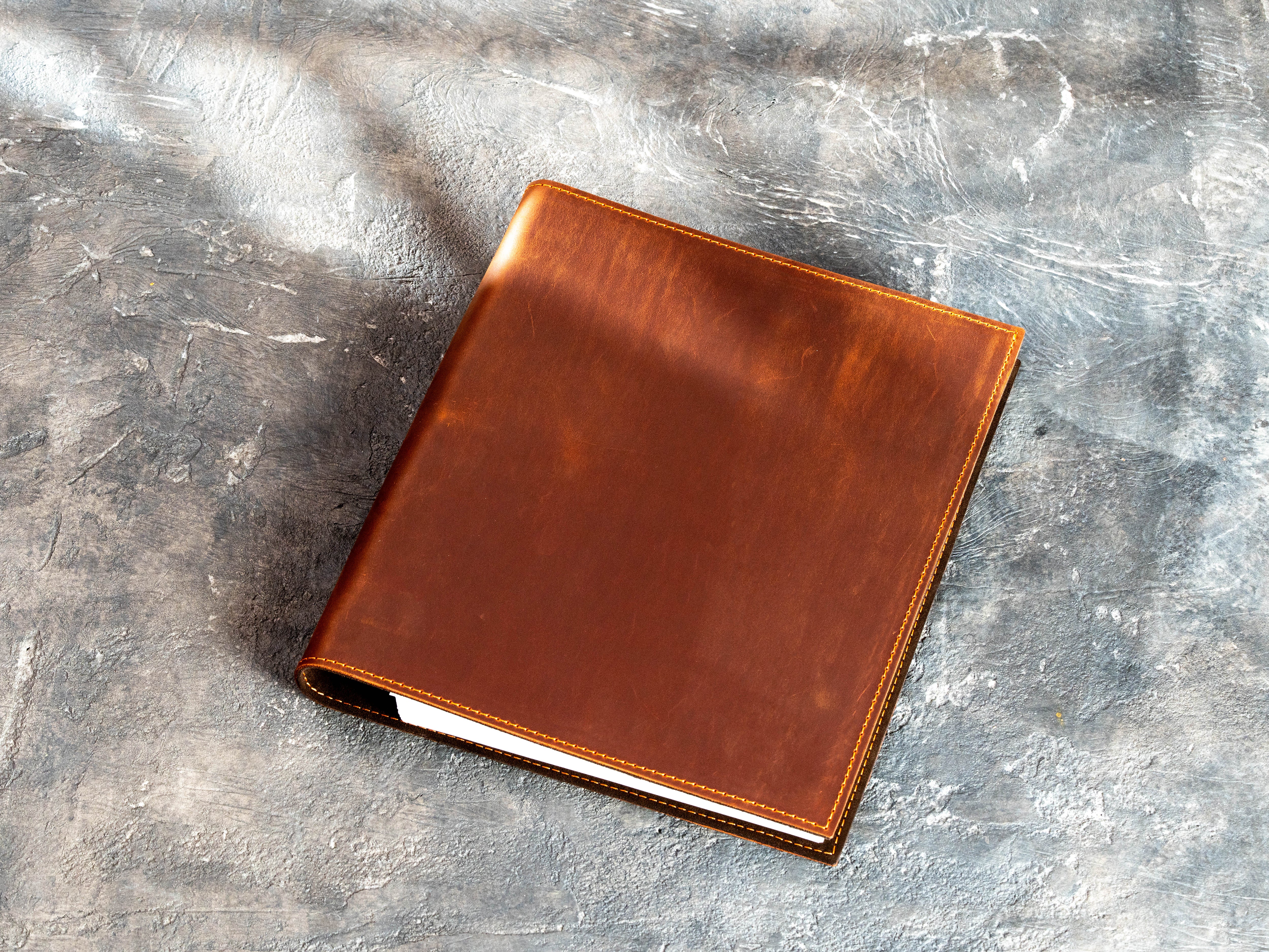 Back view of a copper leather document binder with smooth finish and solid structured cover