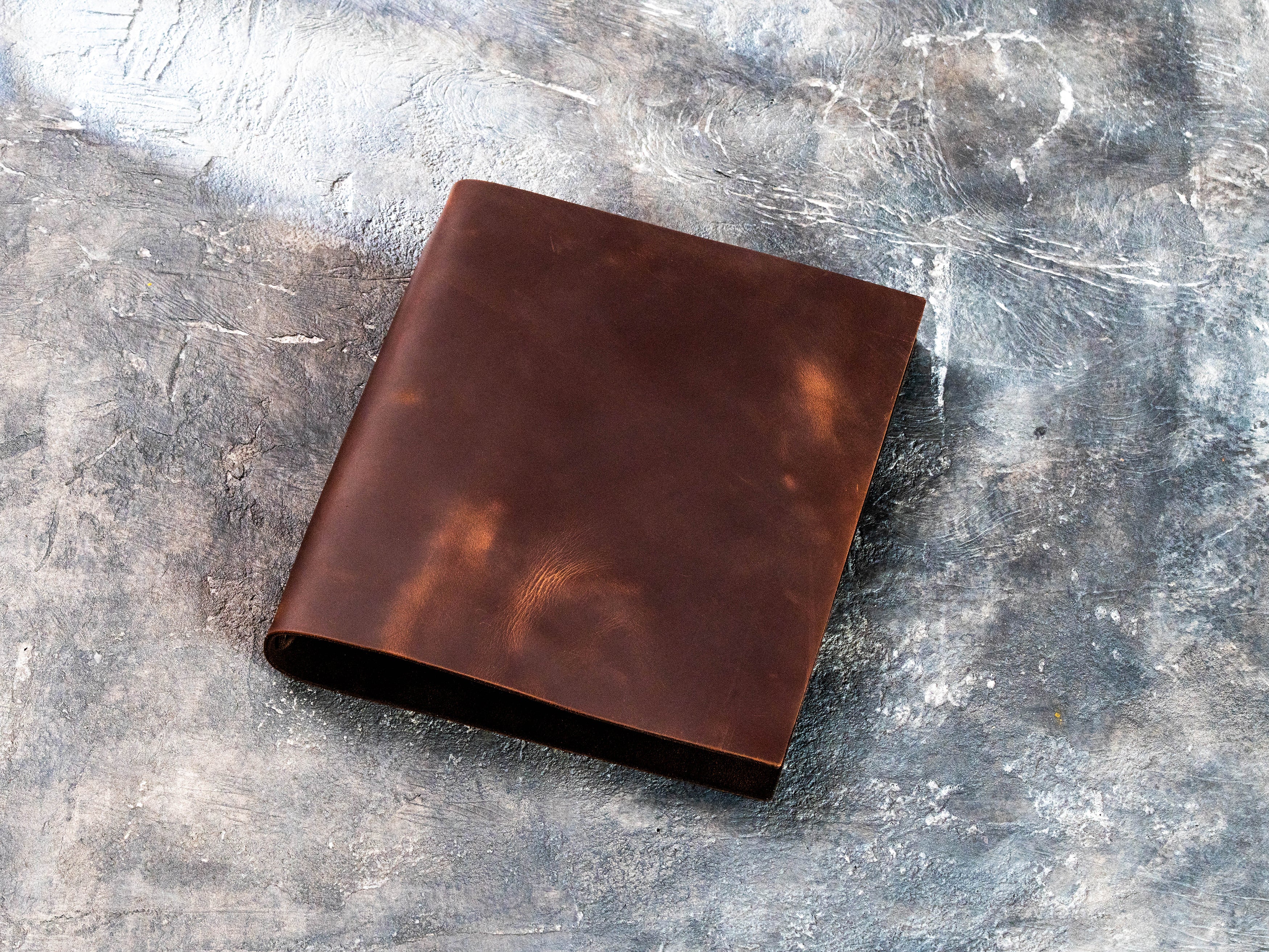 Back view of a soft brown Crazy Horse leather wedding binder with natural vintage markings
