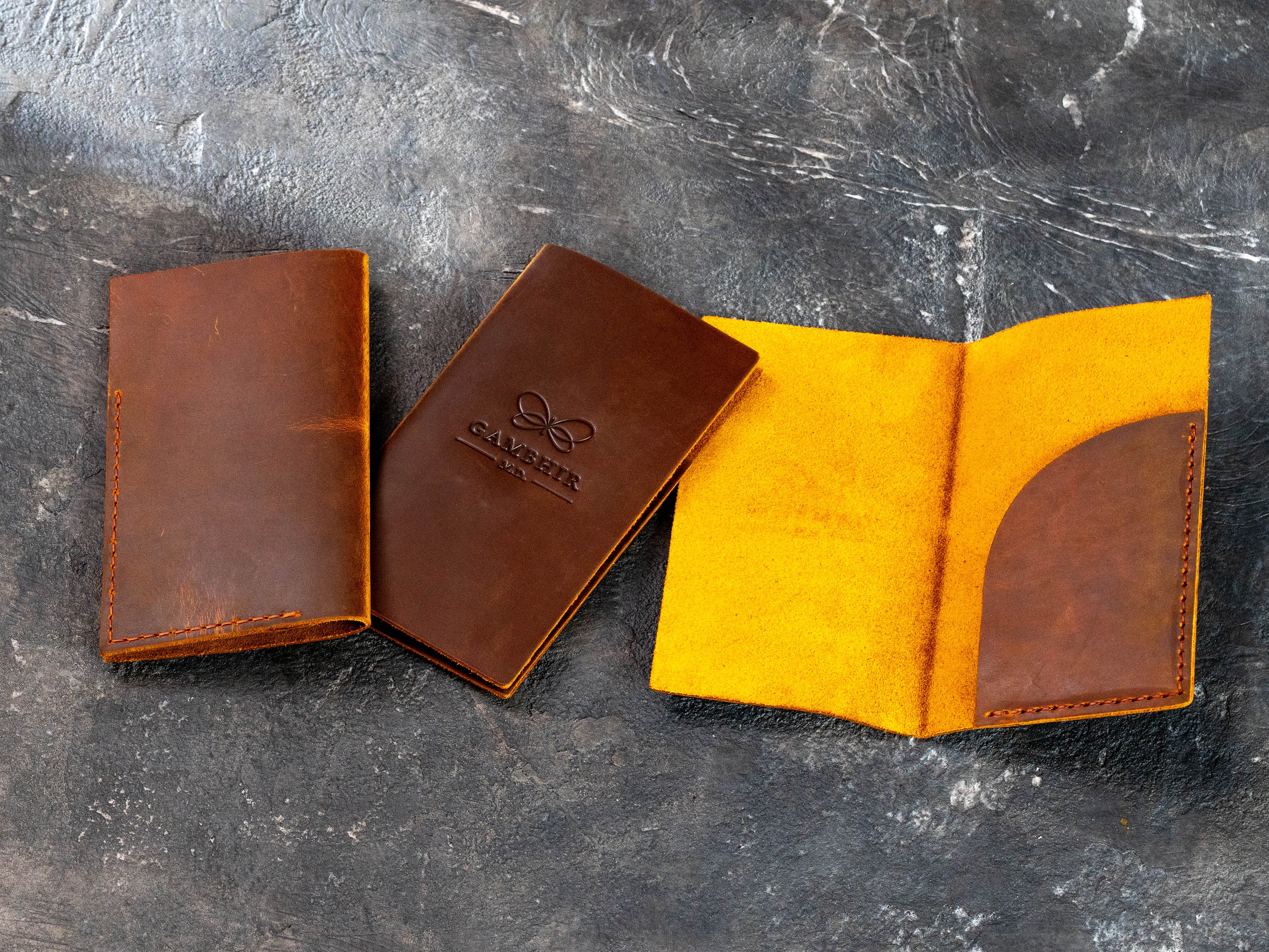 Vintage chestnut leather check presenters with Gambhir M.D. logo, heavily waxed surface, and distressed finish
