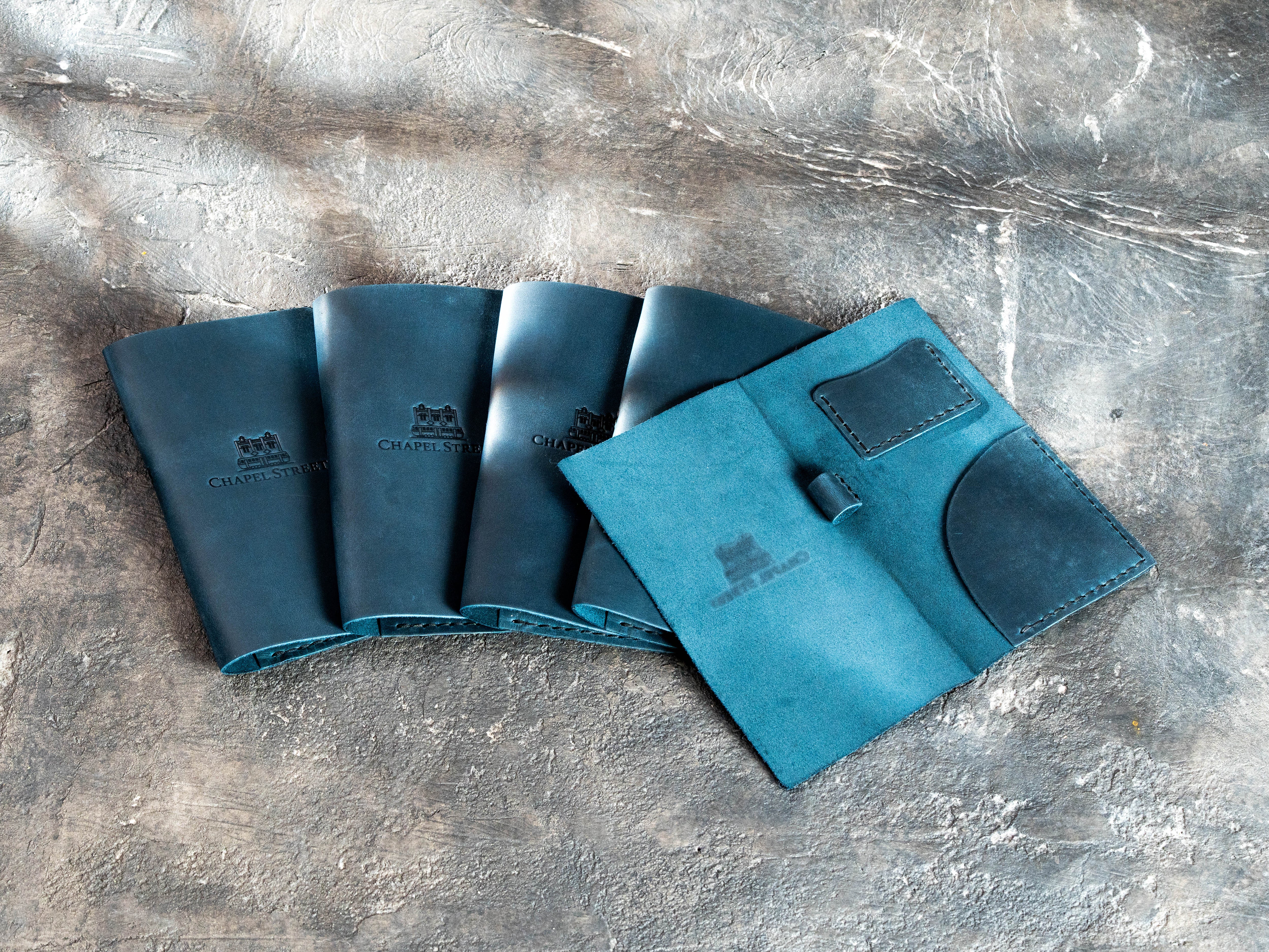Interior view of a blue Crazy Horse leather bill holder with stitched card pocket and pen holder