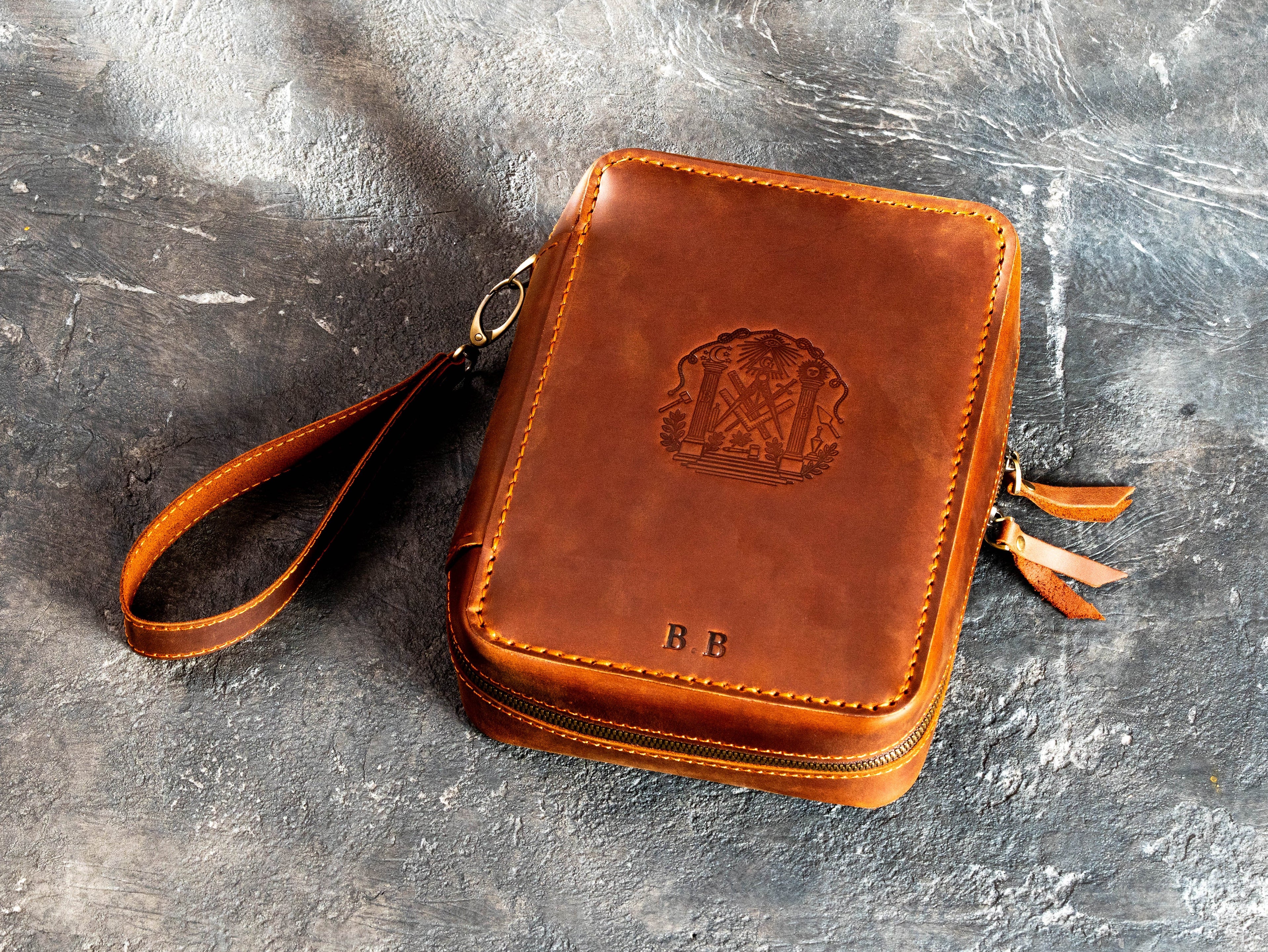 Personalized Crazy Horse leather cigar travel case with a client-provided Masonic-style emblem, B.B. initials, hot embossing, zipper closure, and wrist strap