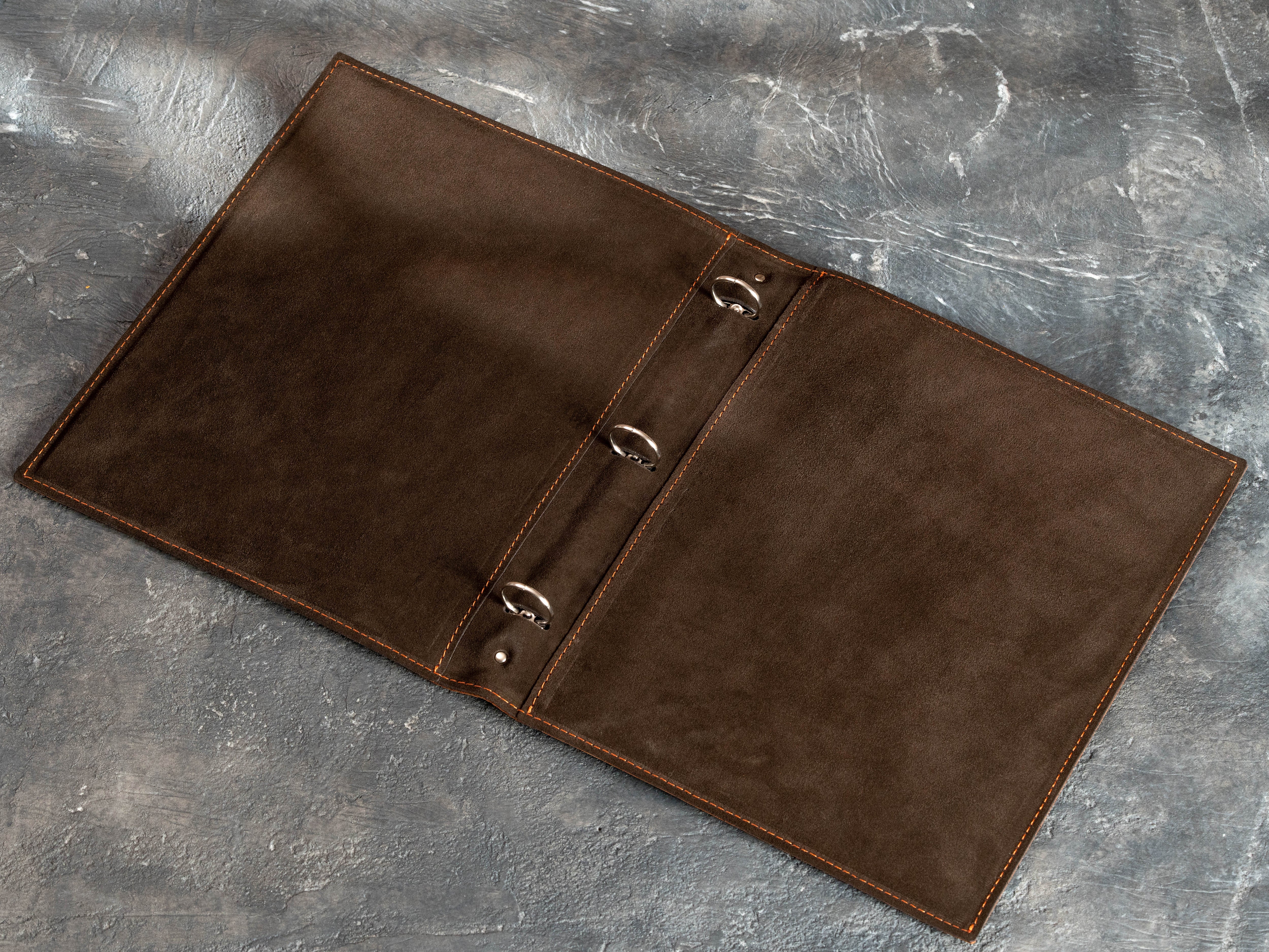 Open copper leather binder with brown suede interior and three round 1-inch rings