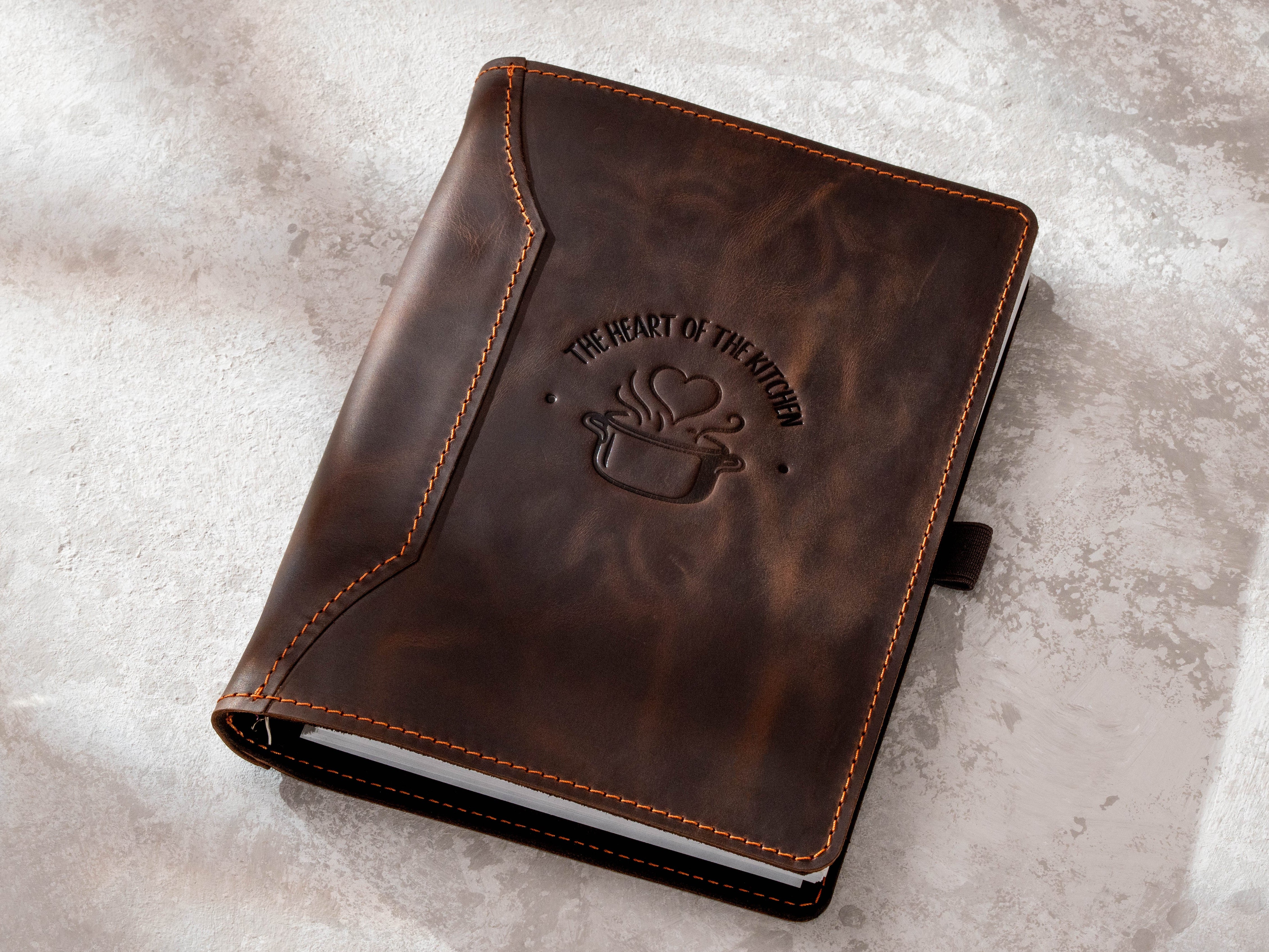 Dark brown leather family recipe book organizer with The Heart of the Kitchen embossed cover design