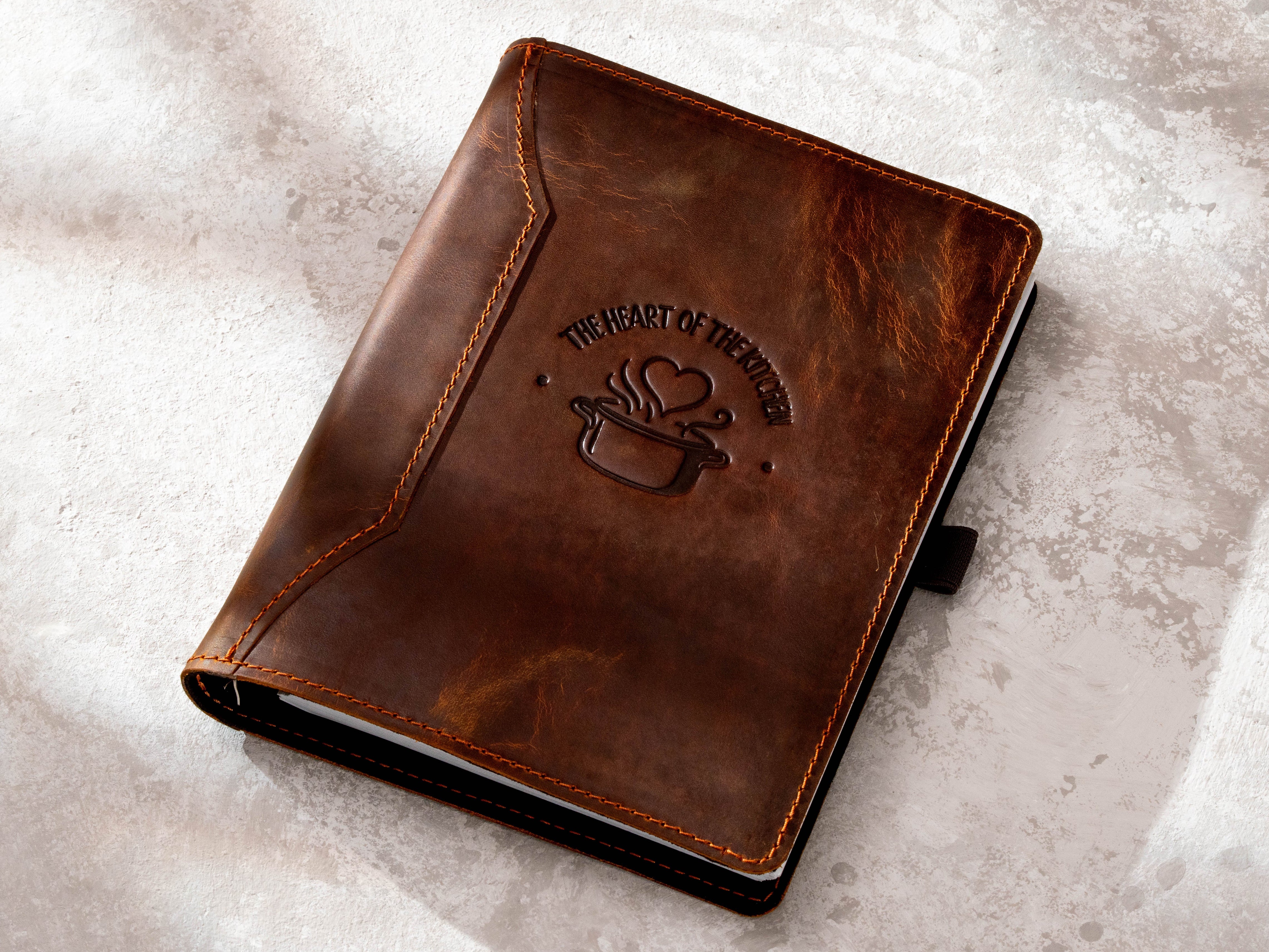 Chestnut leather family recipe binder with The Heart of the Kitchen embossed design and 6-ring cookbook organizer
