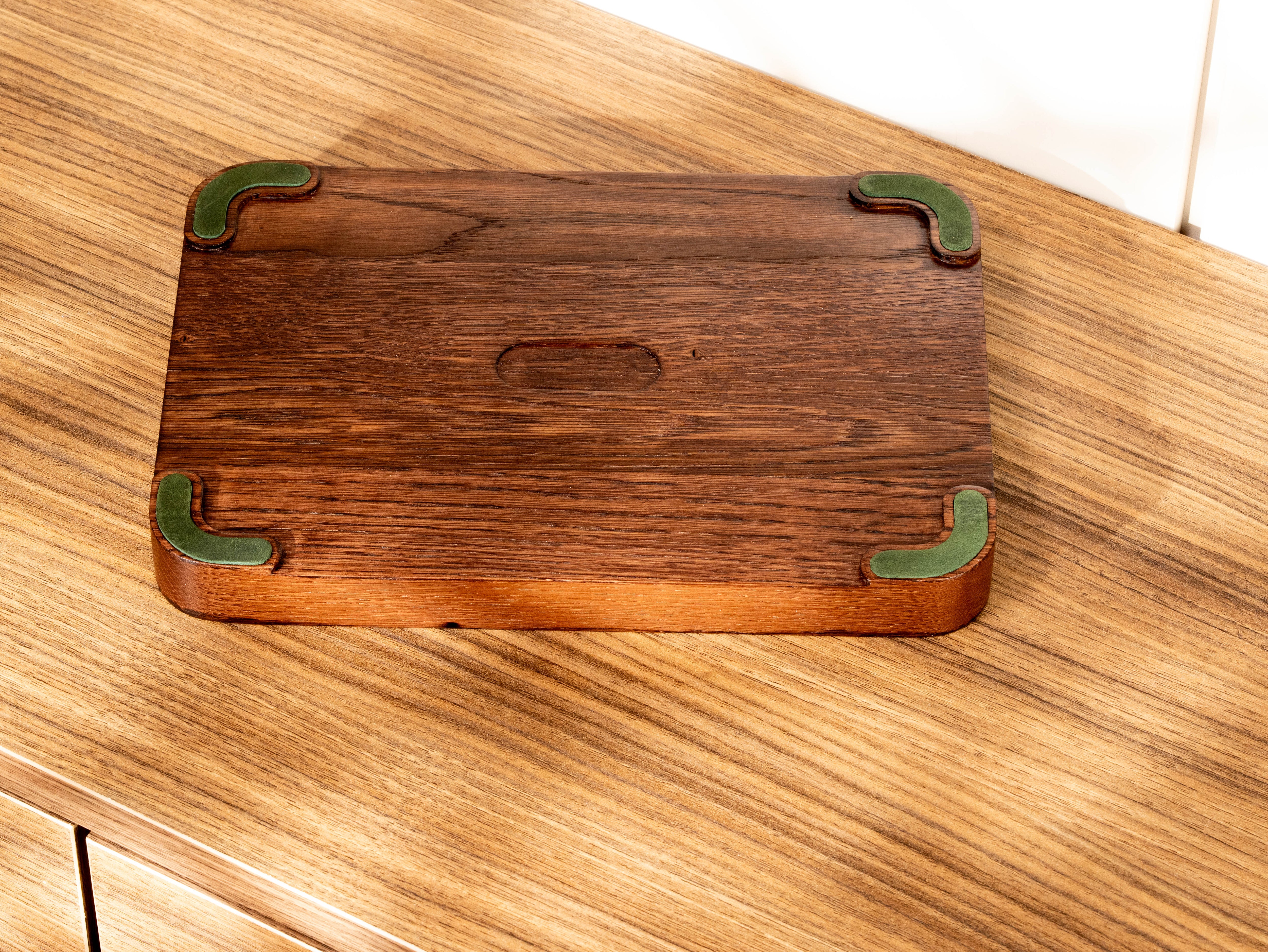 Bottom view of oak wood valet tray with forest green leather feet fitted into custom-milled grooves