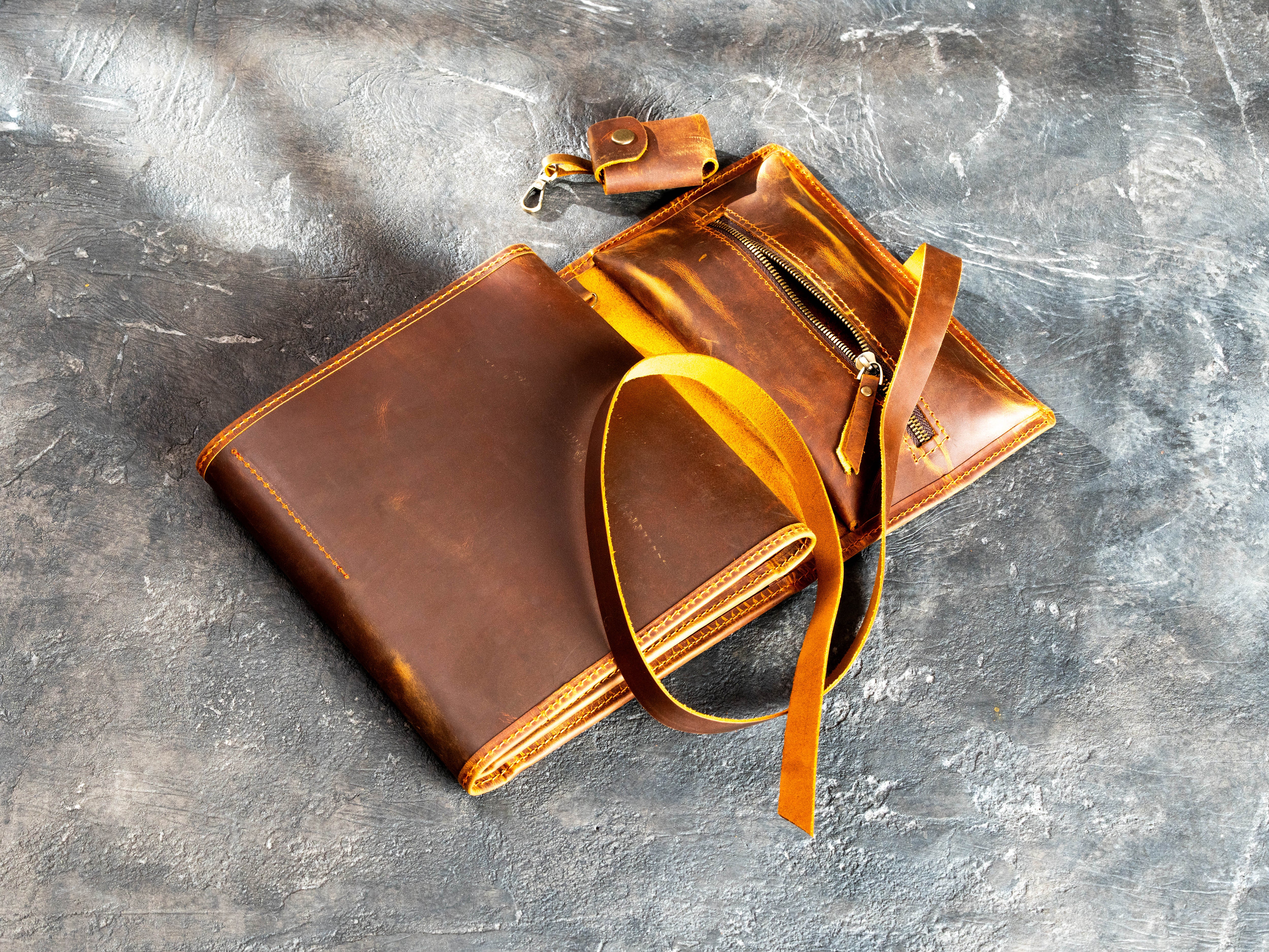 Open leather artist organizer with A5 sketchbook holder, colored pencil loops, removable pencil case, and zipper pocket