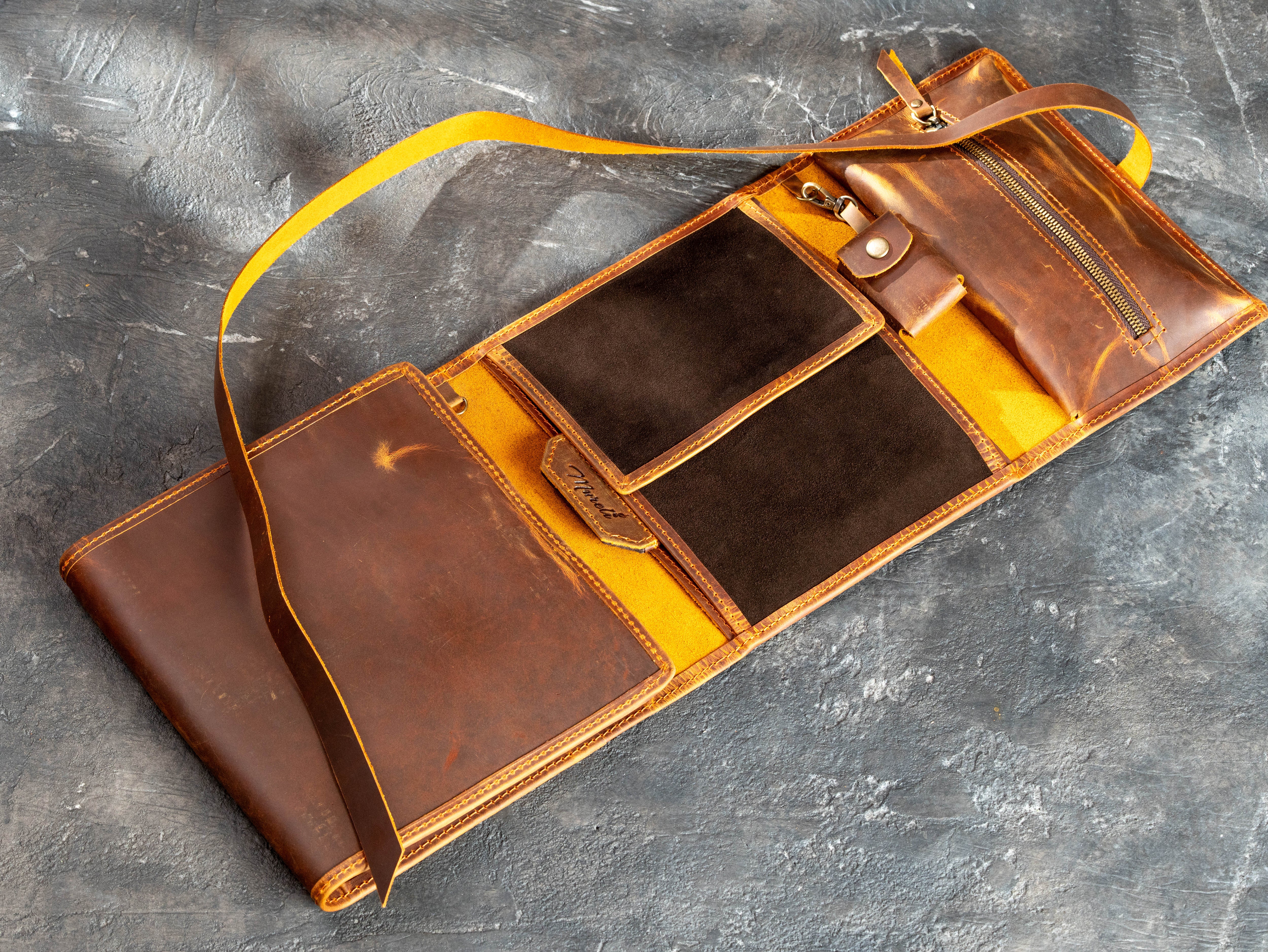 Personalized leather drawing organizer holding an A5 sketchbook, colored pencils, removable case, and art accessories