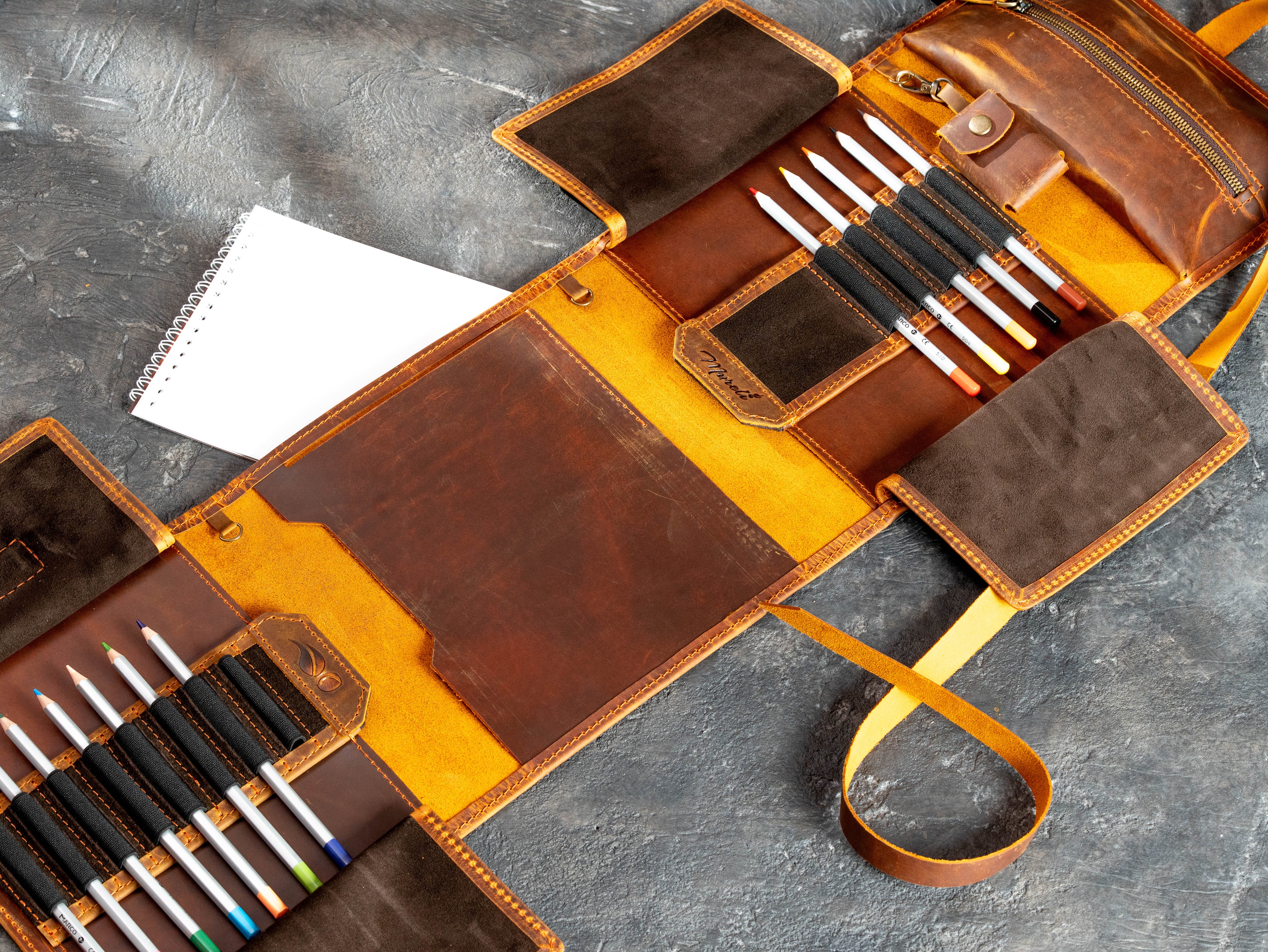 Waxed Crazy Horse leather art supply organizer with pencil loops, sketchbook holder, suede pockets, and zipper storage