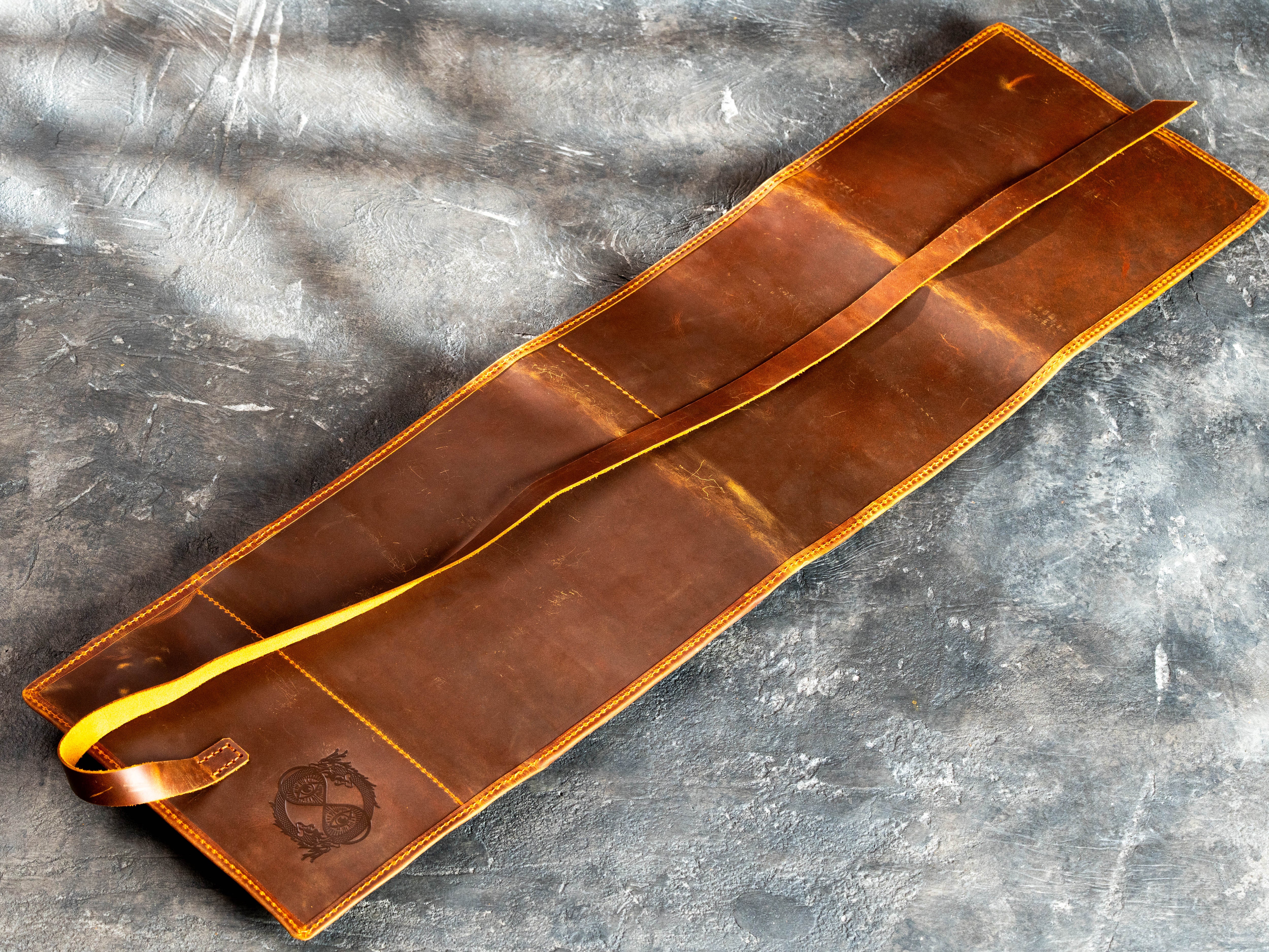 Back view of heavily waxed Crazy Horse leather artist organizer showing natural scratches, scuffs, and tonal variations