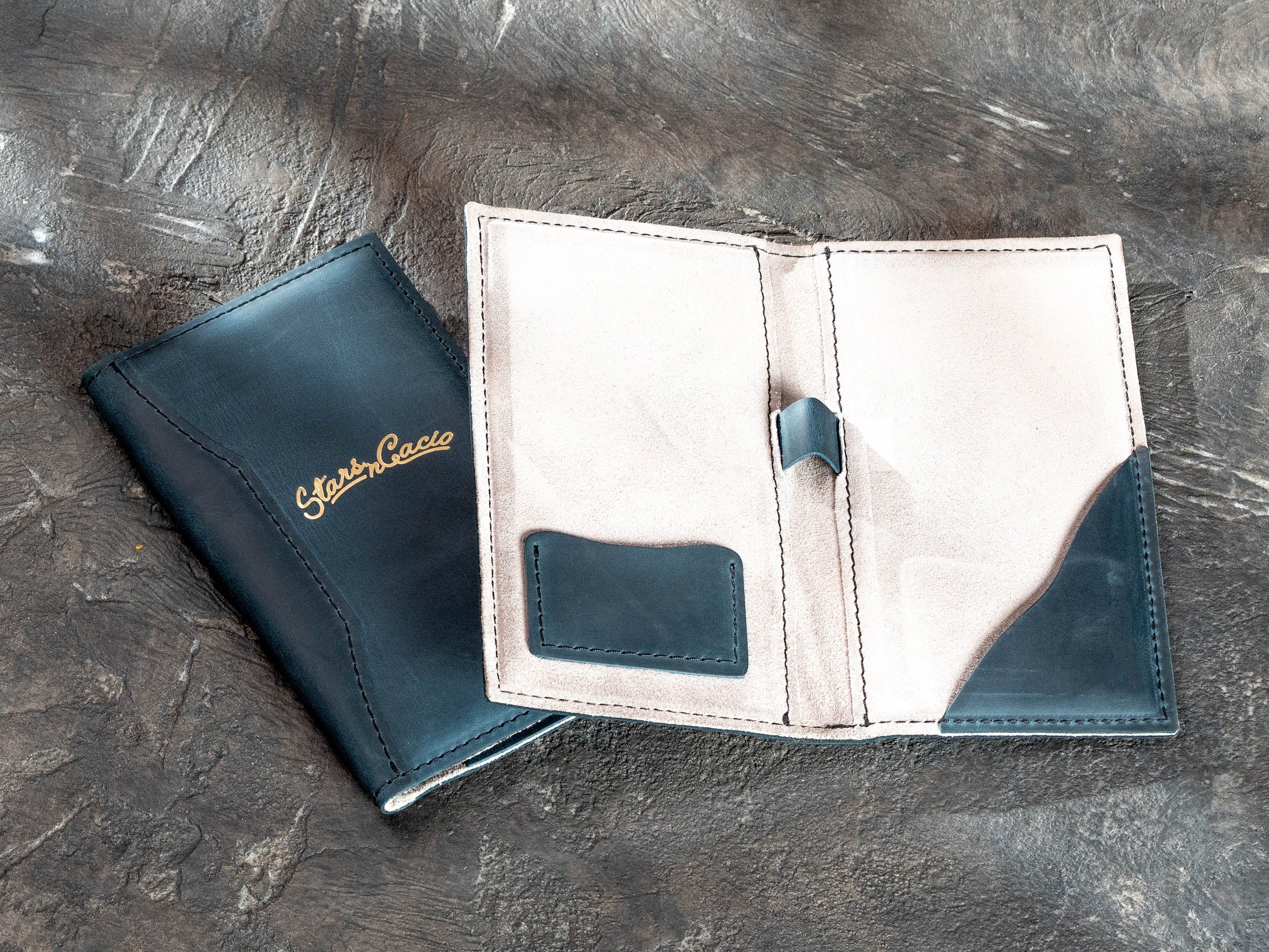 Open blue leather check presenter with gray suede interior, card pocket, pen loop, and curved receipt pocket