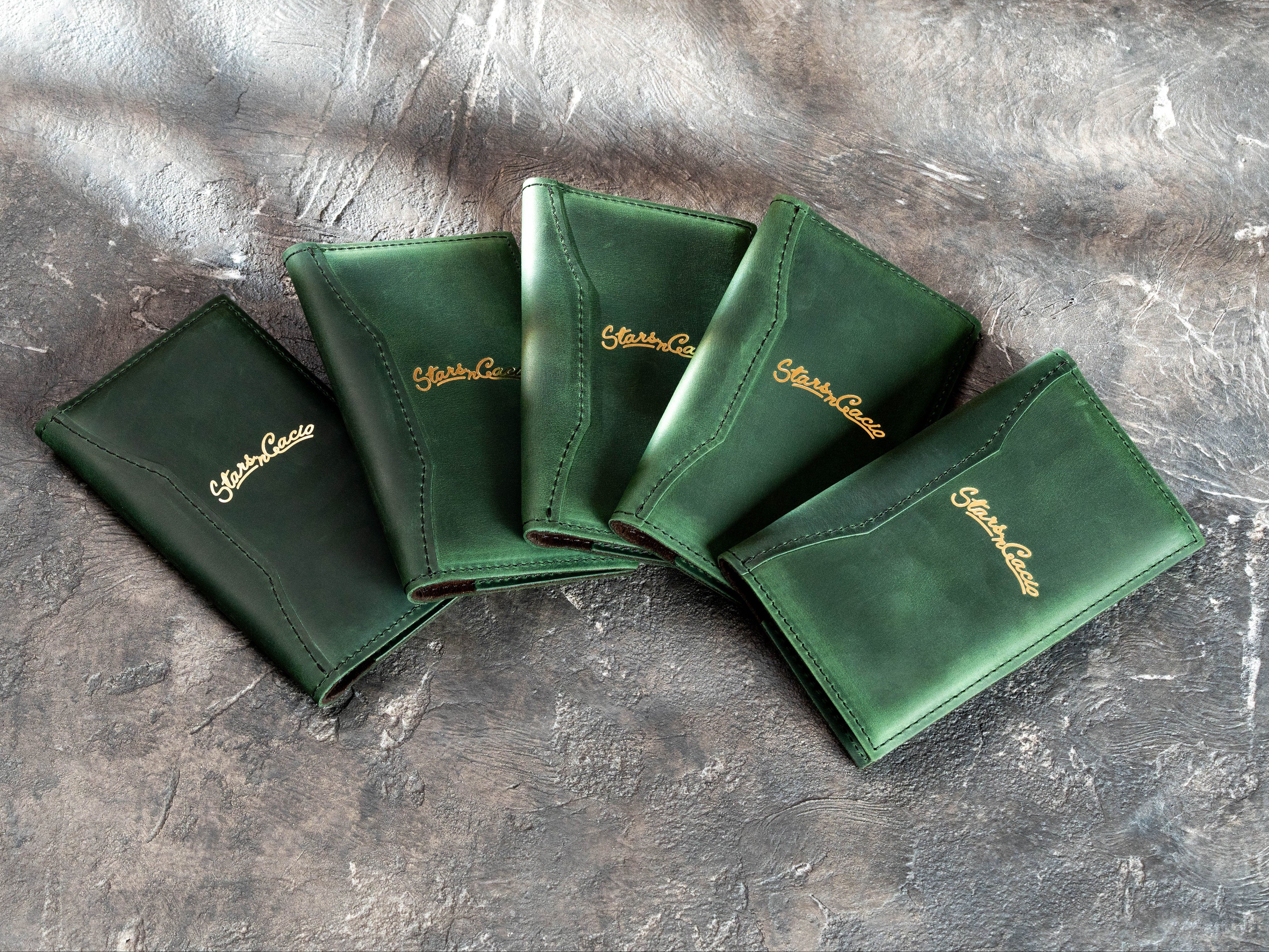 Set of custom green Crazy Horse leather restaurant bill holders with gold foil Star in Cacio logos