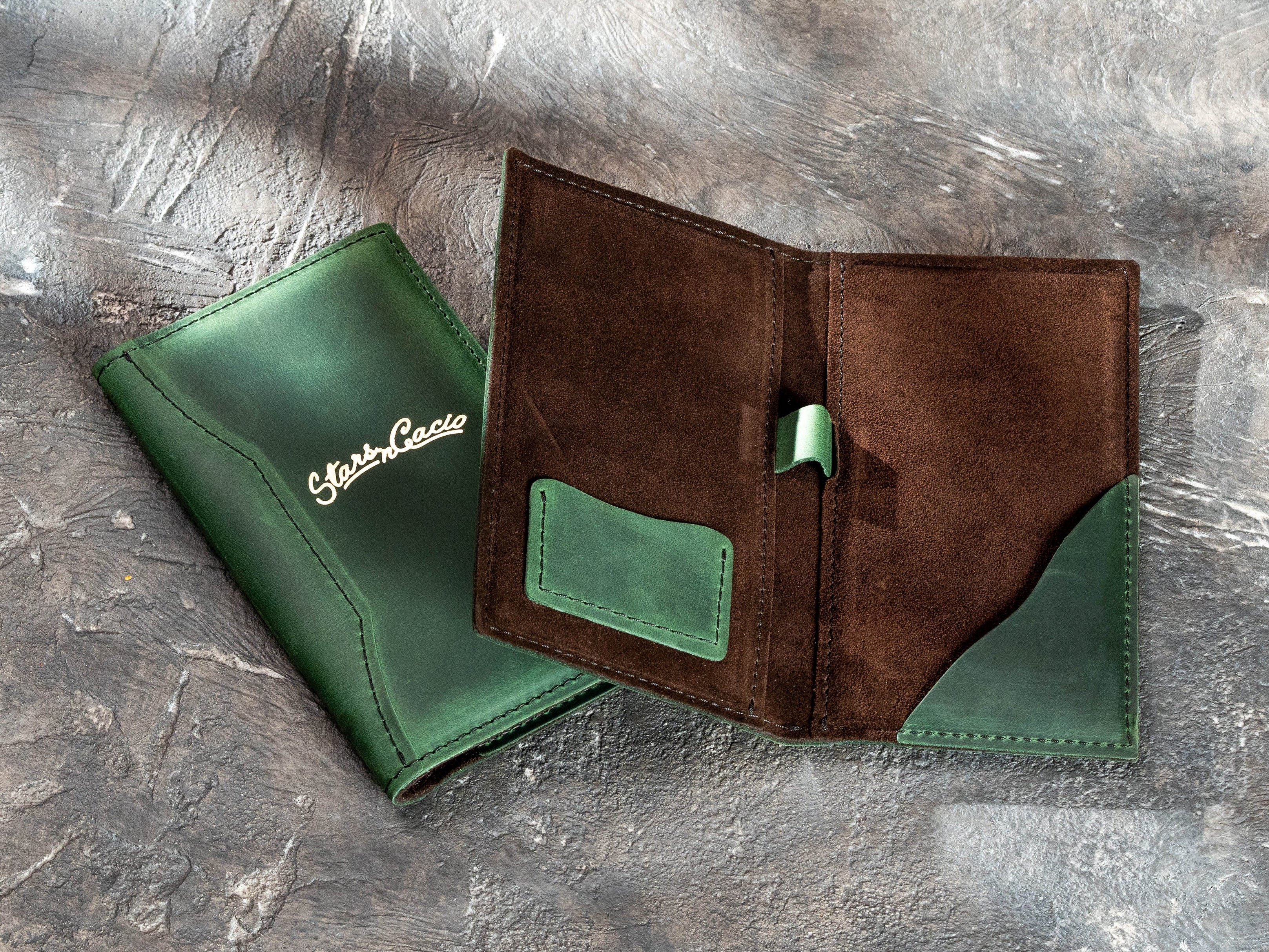 Open green leather bill holder with brown suede interior, payment card pocket, pen loop, and curved receipt pocket