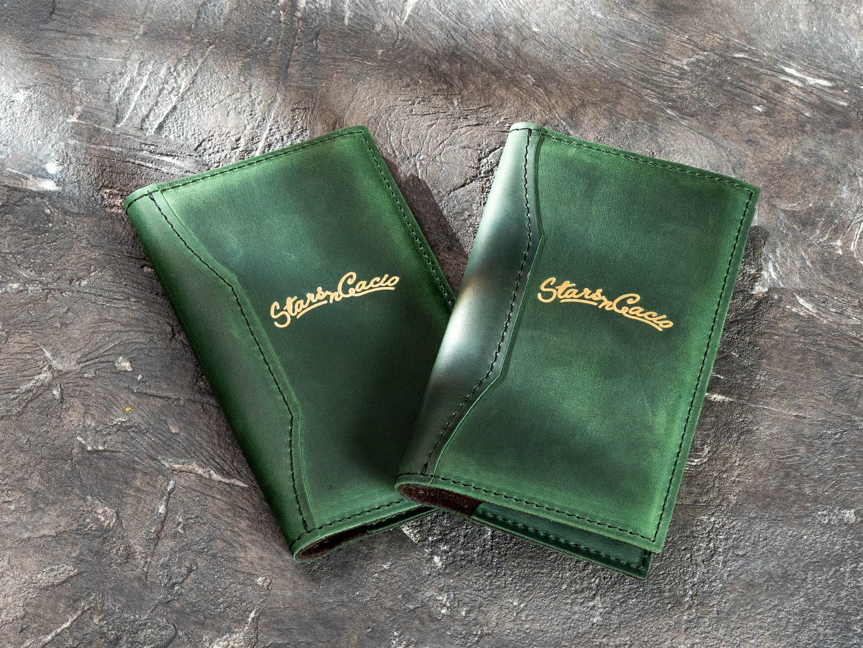 Two custom green leather bill holders made for Star in Cacio with gold foil logos