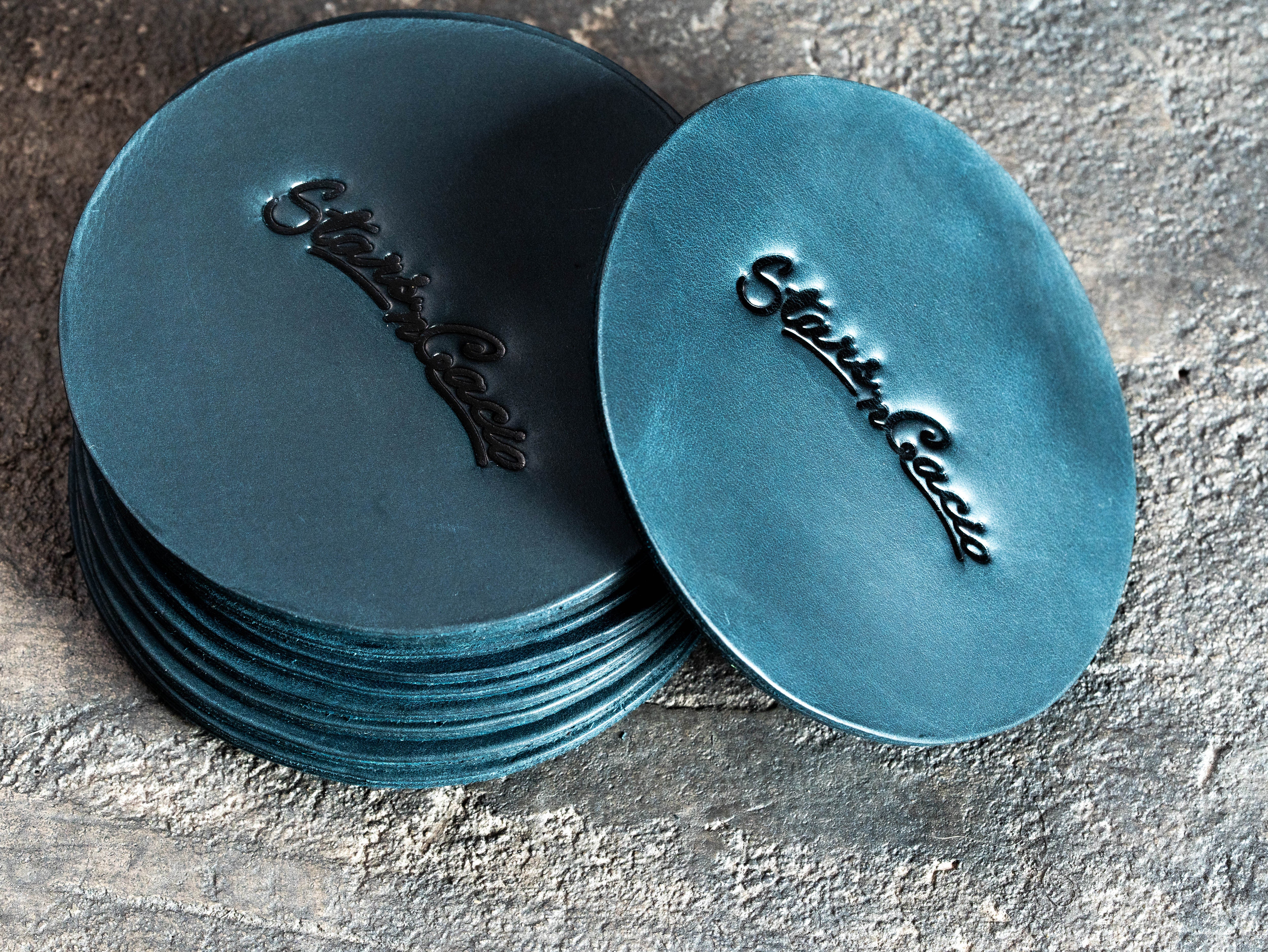 Custom blue Crazy Horse leather coasters with blind embossed Star in Cacio logo