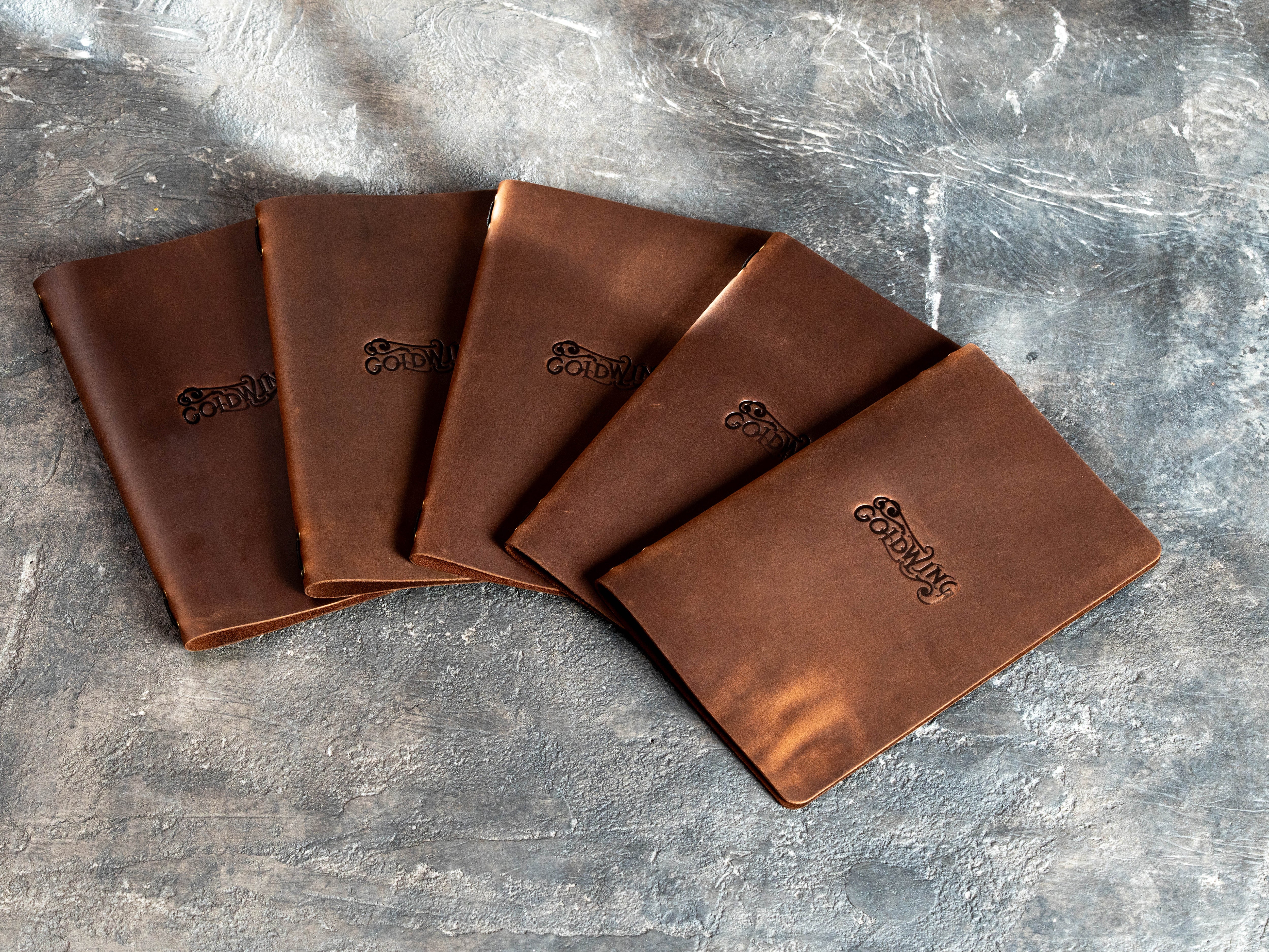 Set of custom brown Crazy Horse leather bar menu covers with blind embossed Goldwing logos