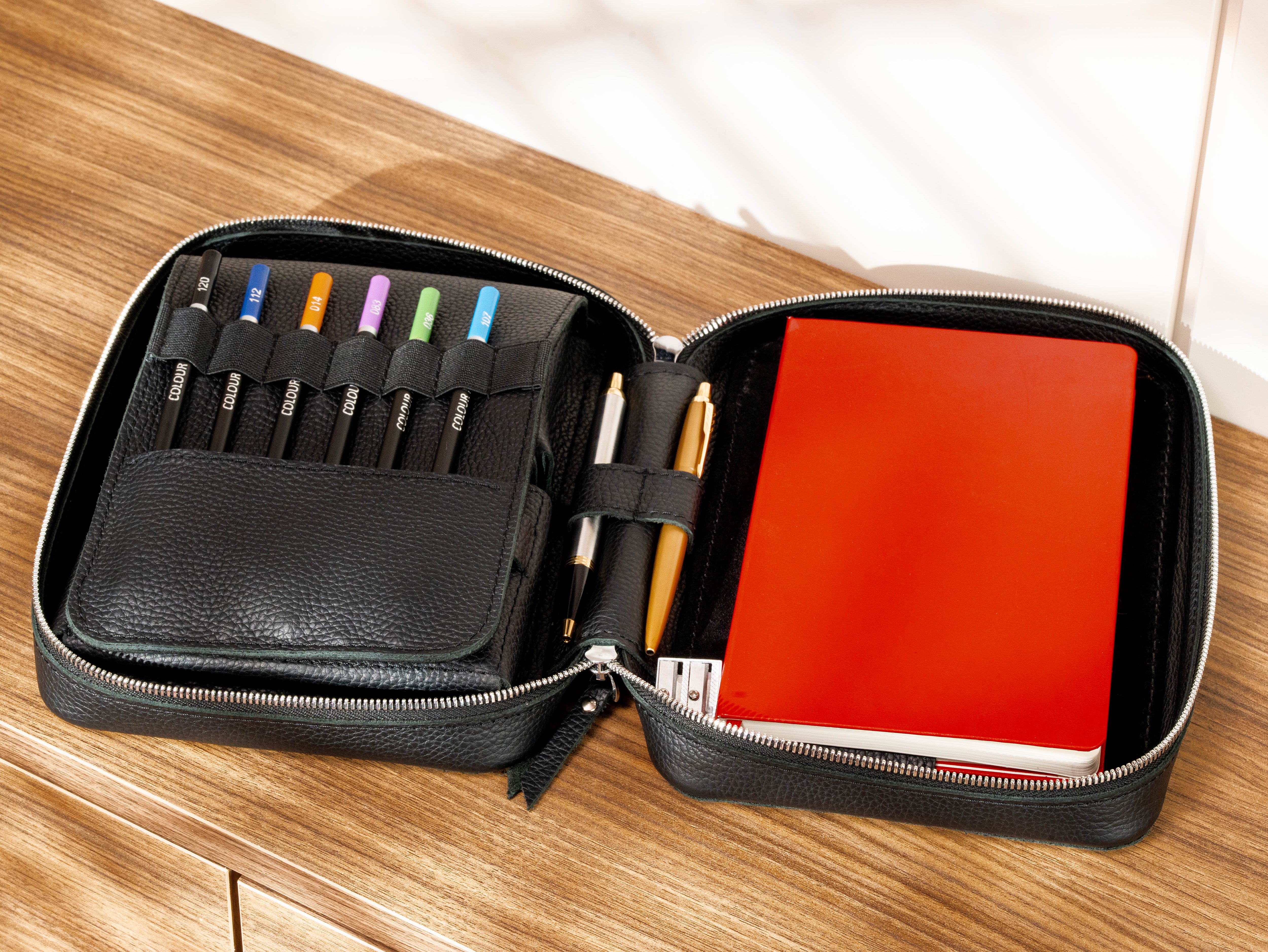 Black Floater leather artist organizer with A5 sketchbook, colored pencils, pens and zippered travel case