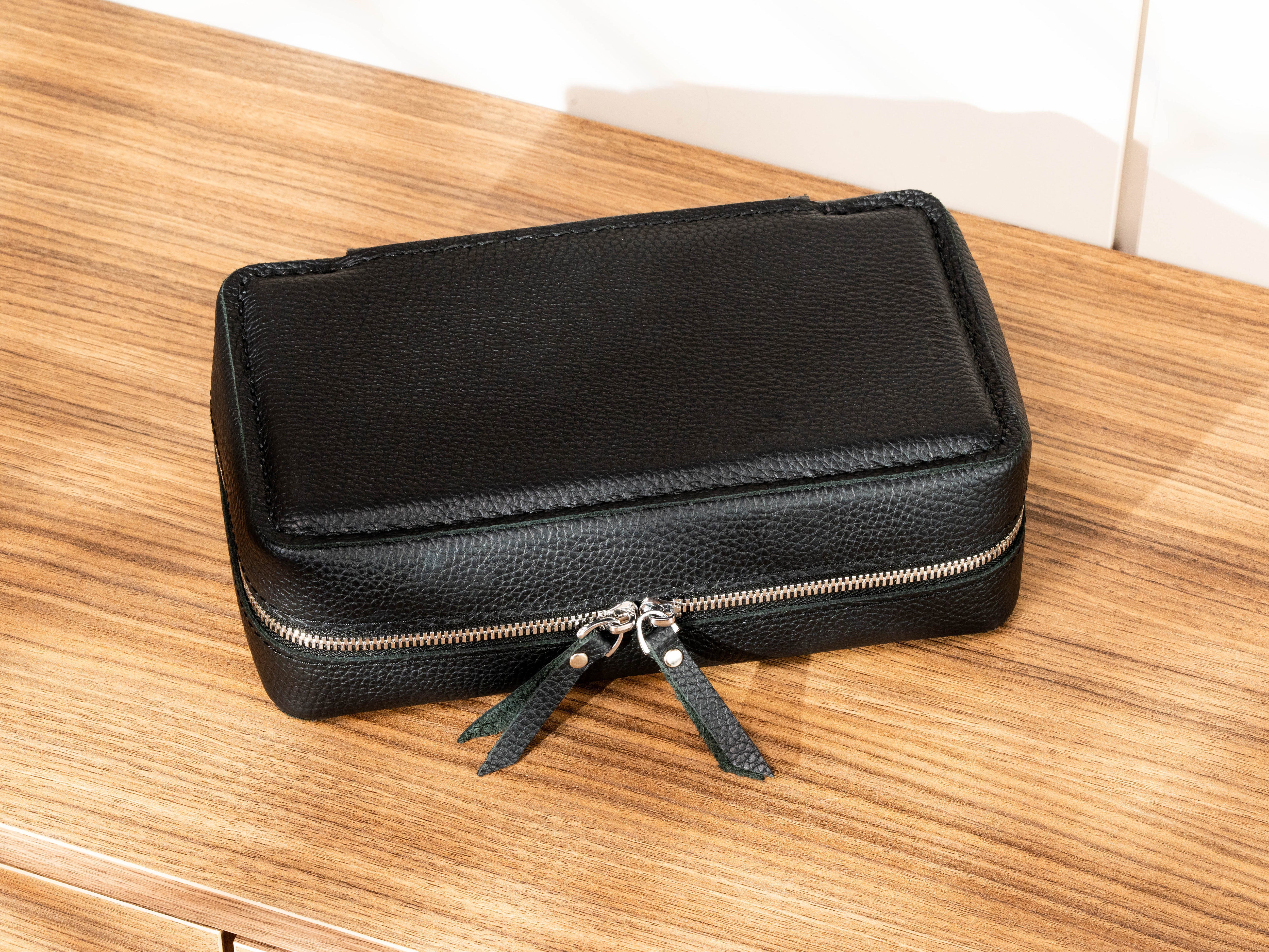 Front view of black leather travel cigar case with double zipper and compact structured construction