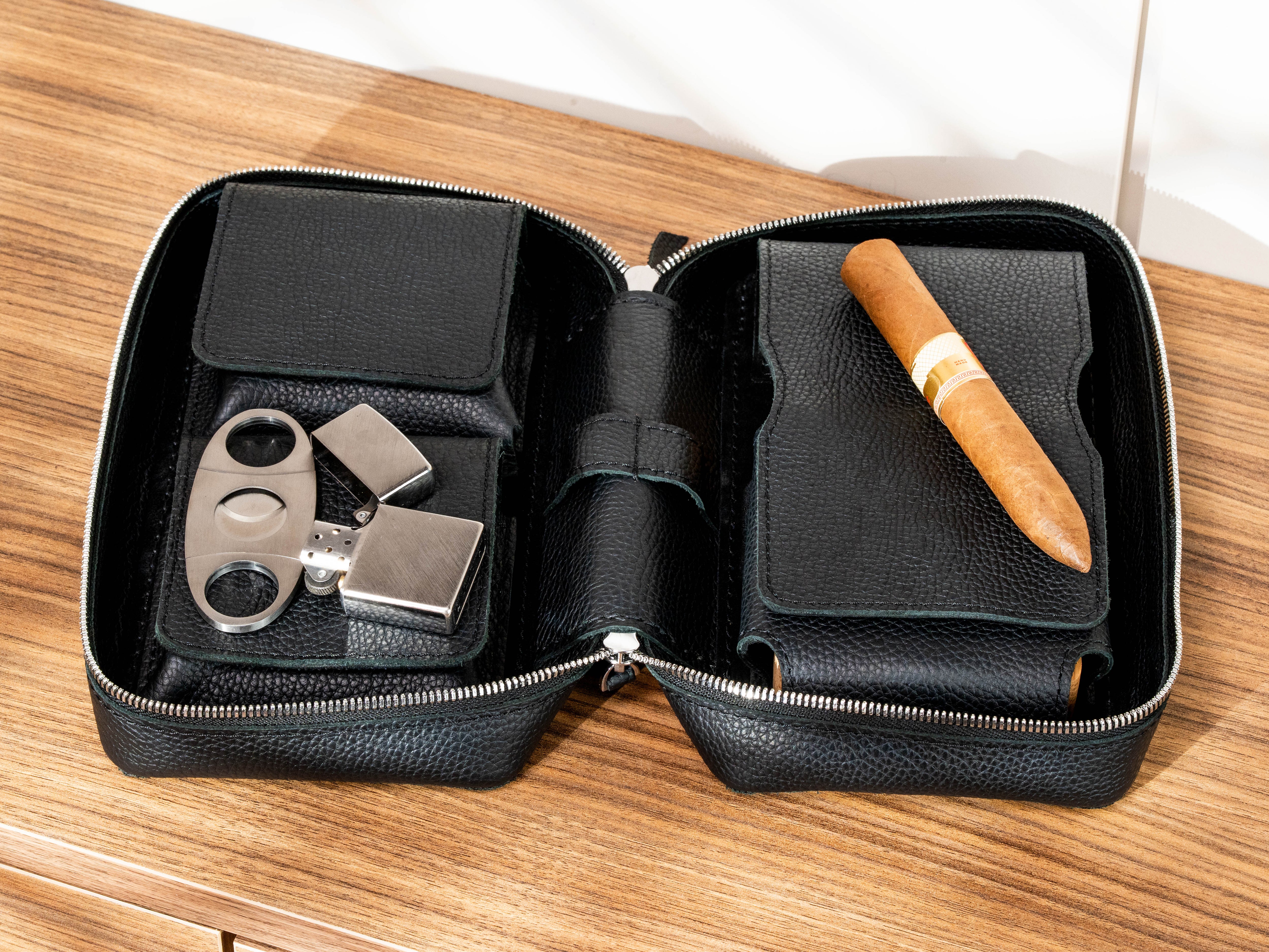 Open black leather cigar case with two accessory pockets, cigar compartment, cutter and lighter storage