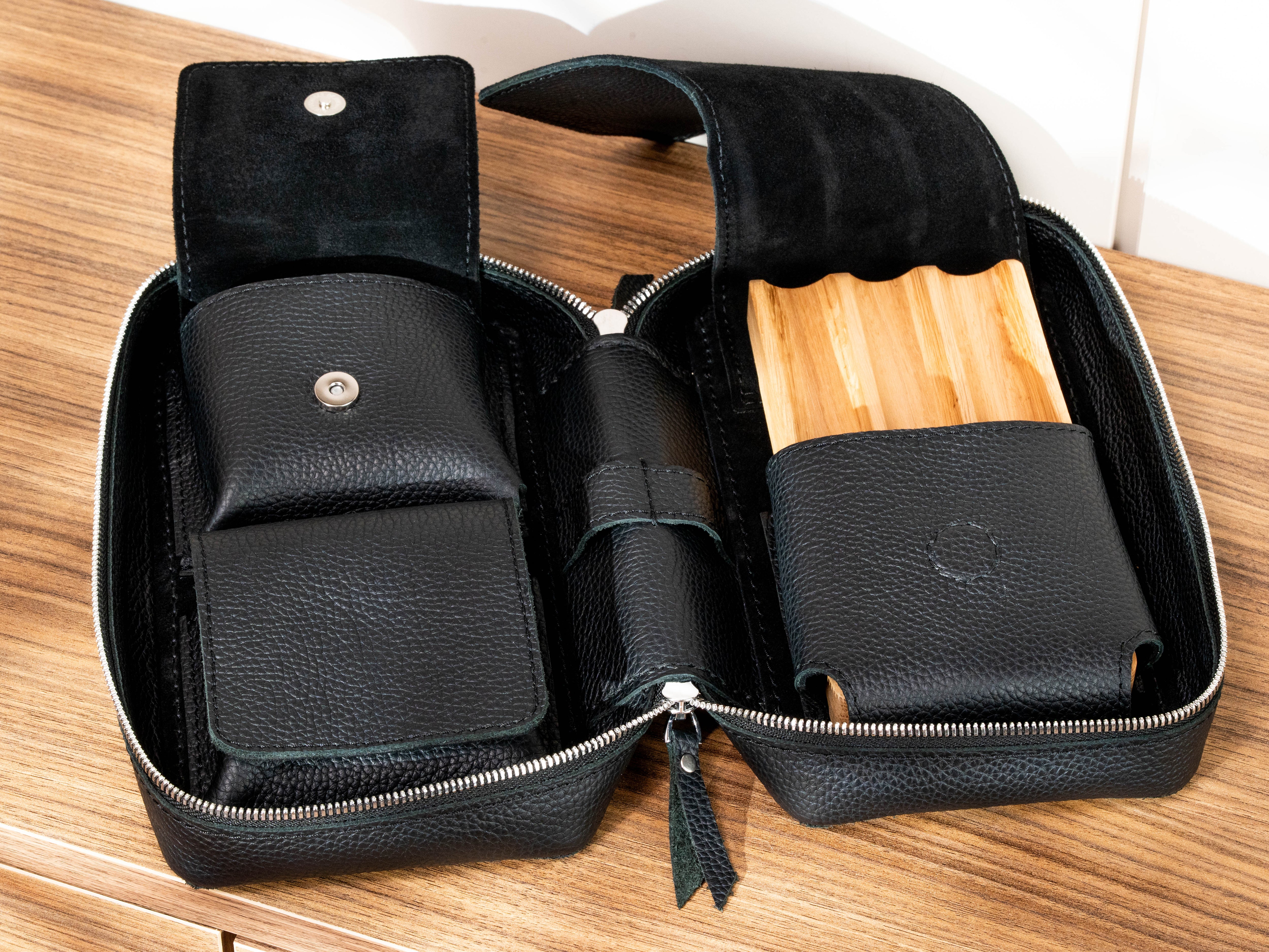 Open travel cigar case showing removable oak cigar tray and separate leather accessory storage pockets