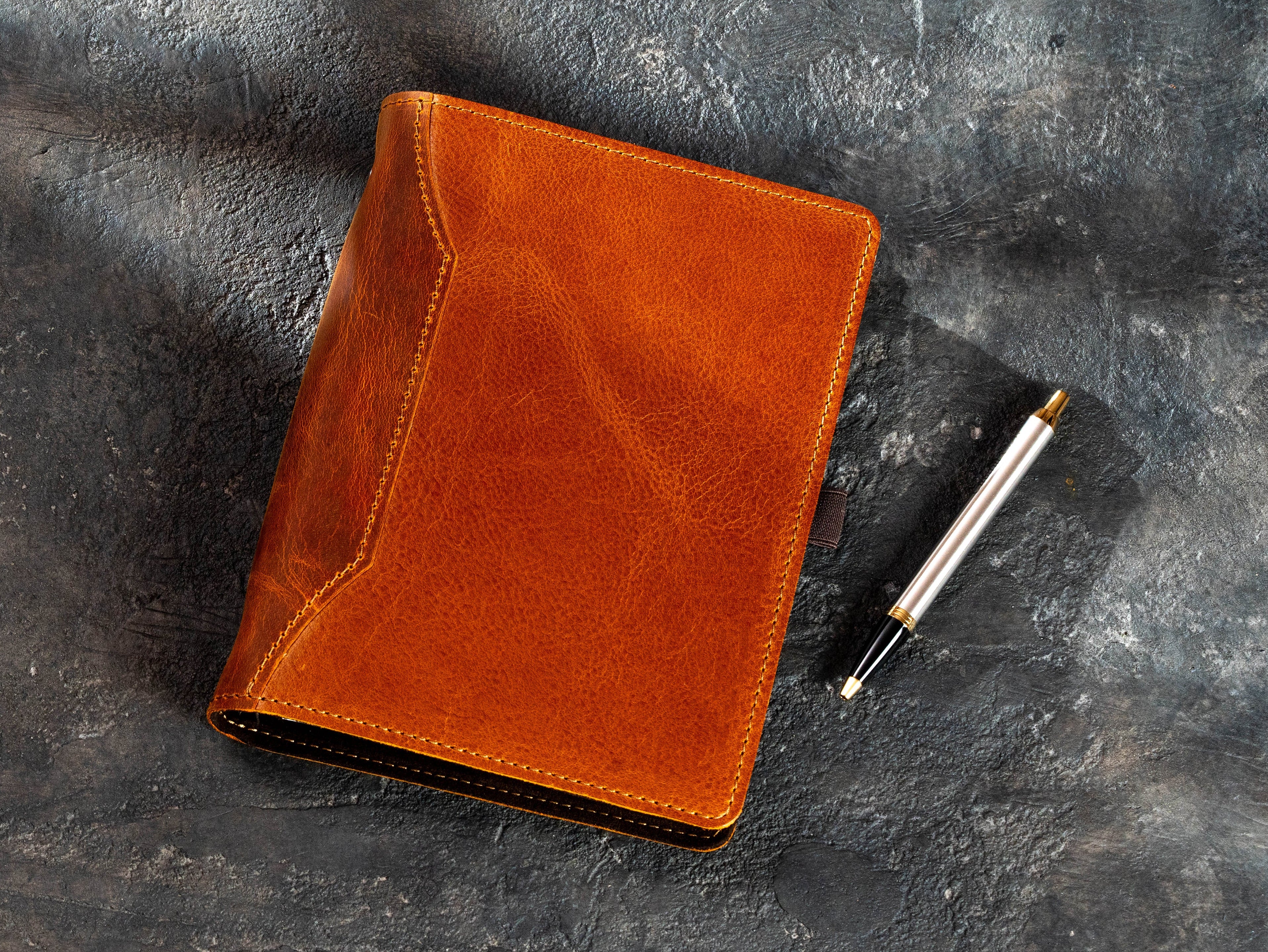Refillable leather journal beside removable lined A5 pages in Camel and Chestnut colors