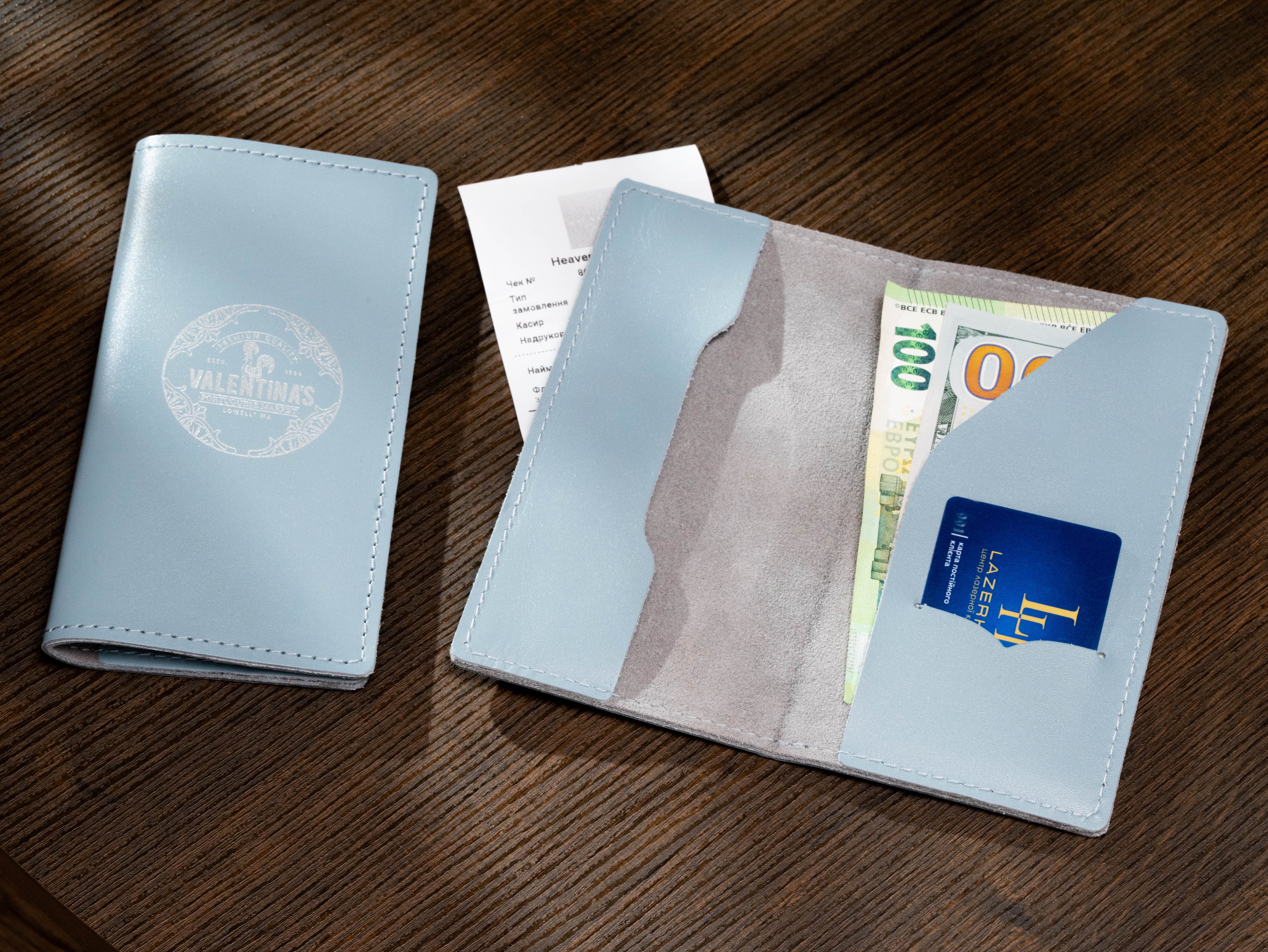 Custom ice blue leather receipt holder shown open and closed with branded logo, cash and card storage