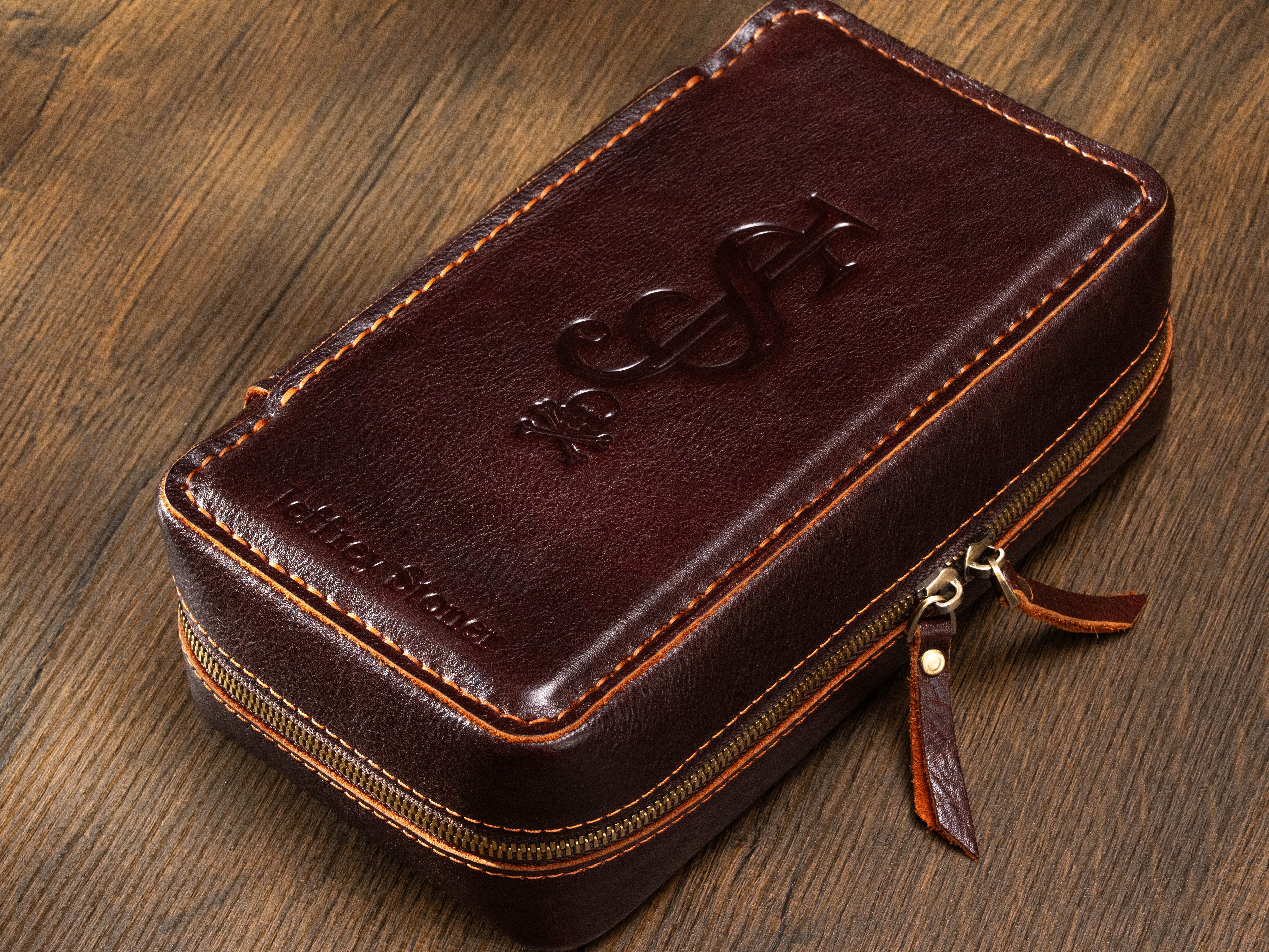 Close-up of personalized dark brown leather cigar case with large custom monogram and name embossing